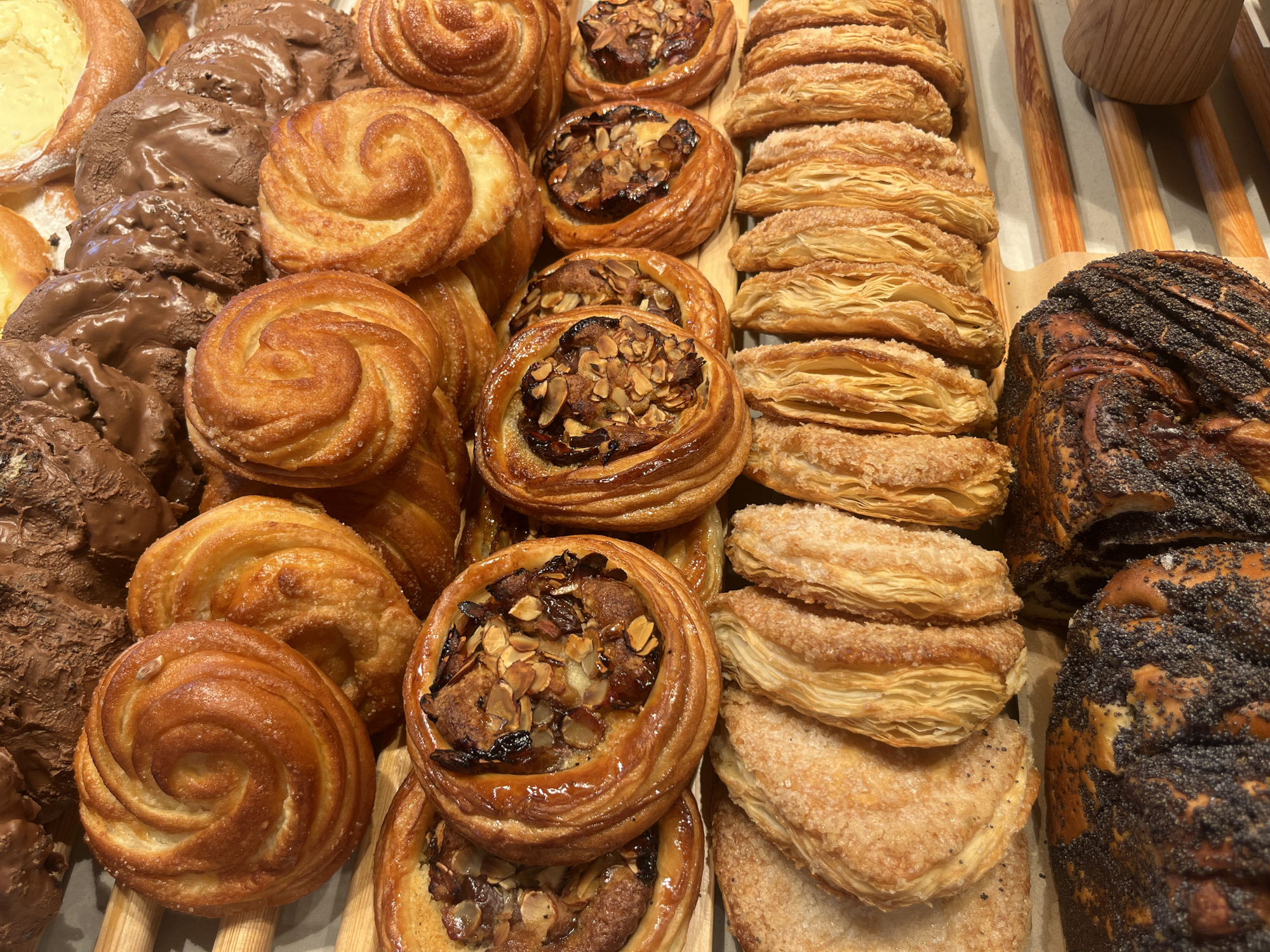 Overhead look at a mix of cinnamon rolls and danishes on wood