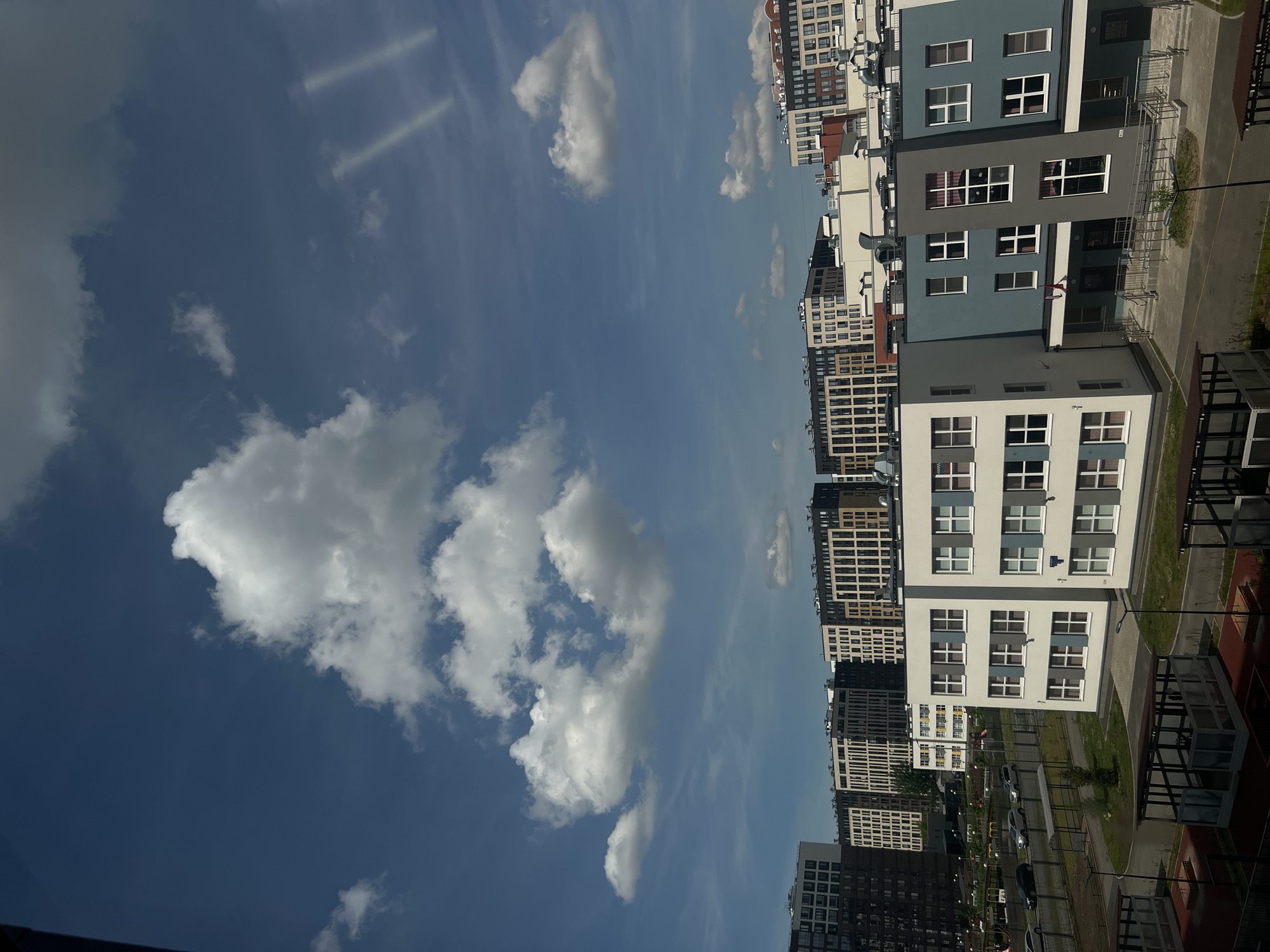 Residential complex with playground observed under cloudy skies