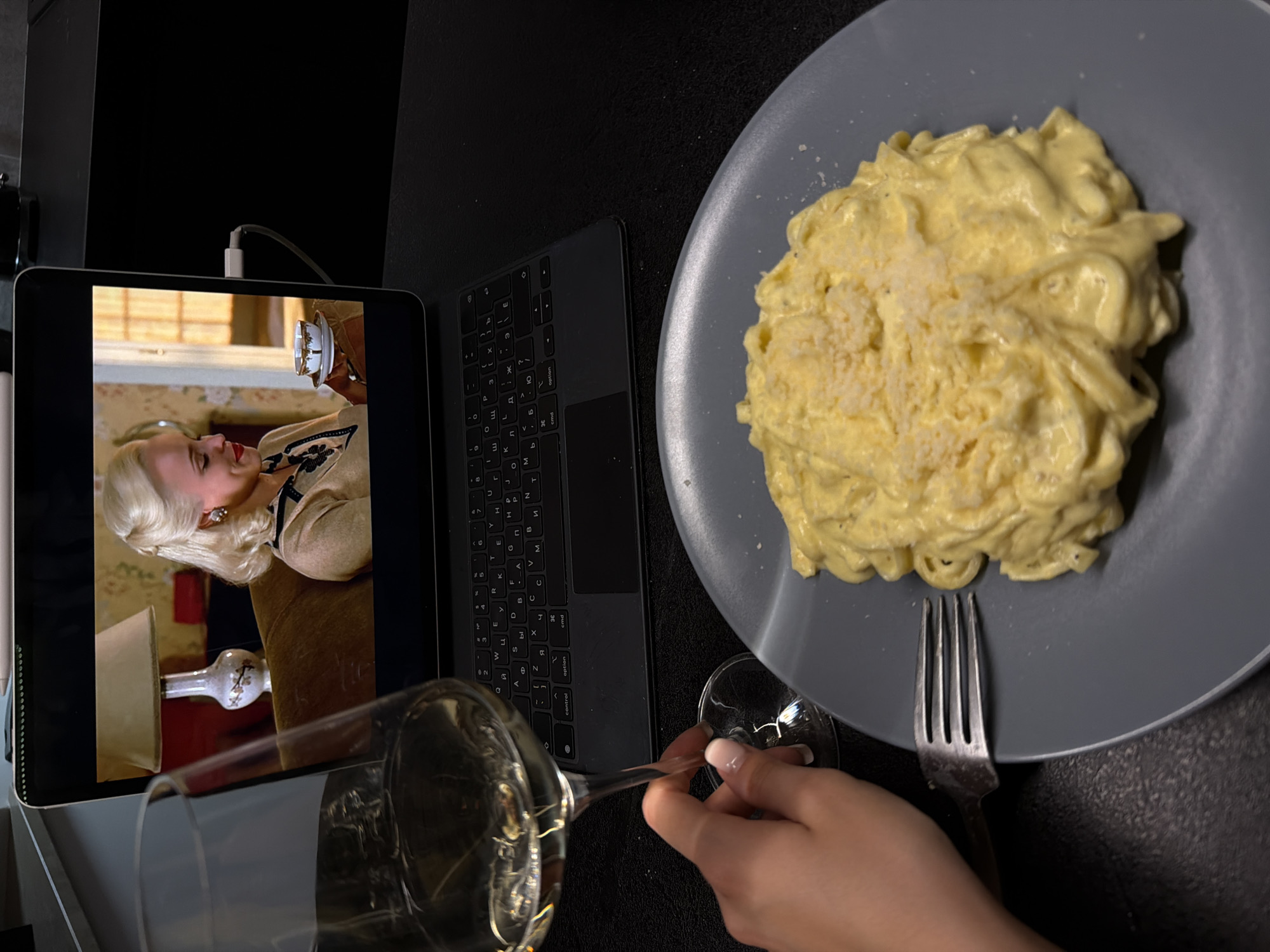Tablet and items documented on dark surface arrangement