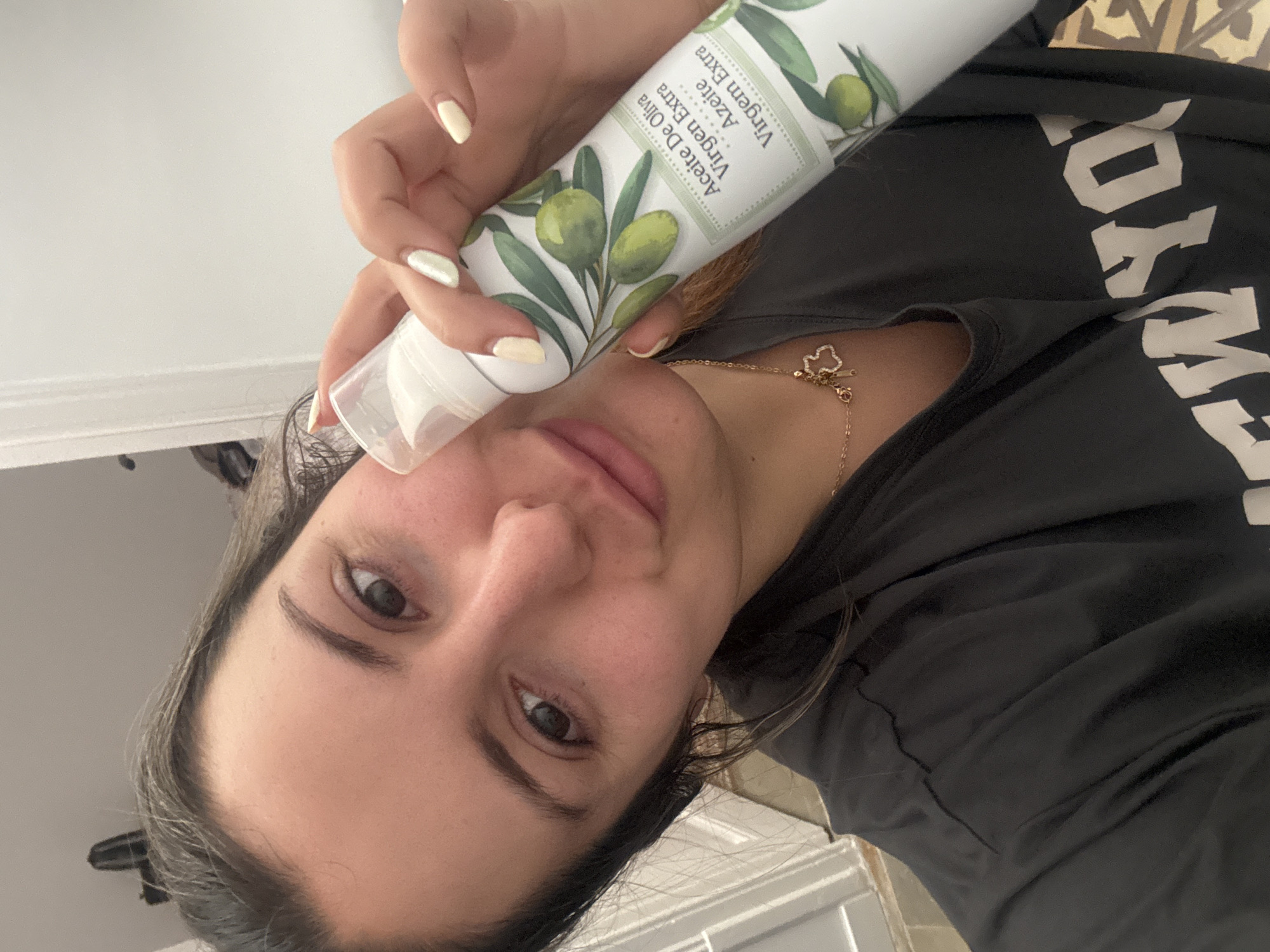 Woman poses with olive oil bottle in Barcelona morning scene
