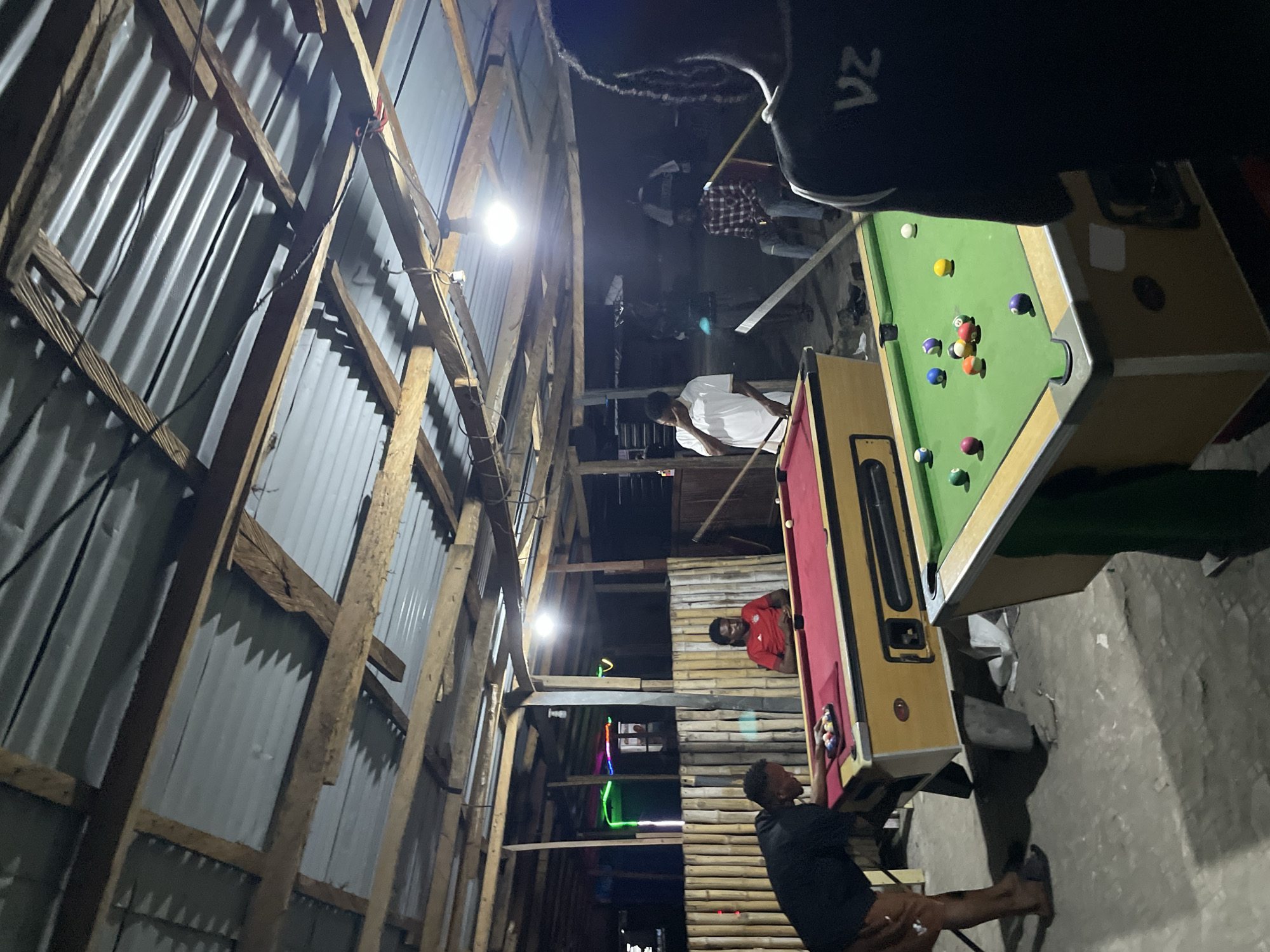 Nighttime pool game documented at local hall in Ado, Nigeria