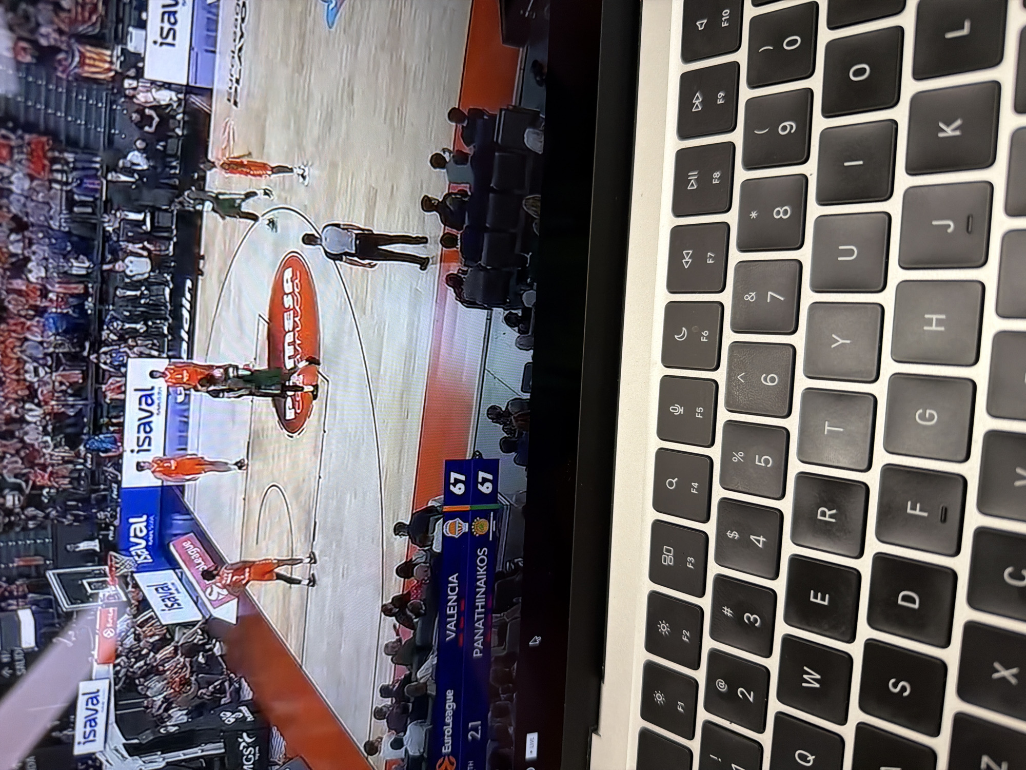 Person watches basketball game on laptop in New York