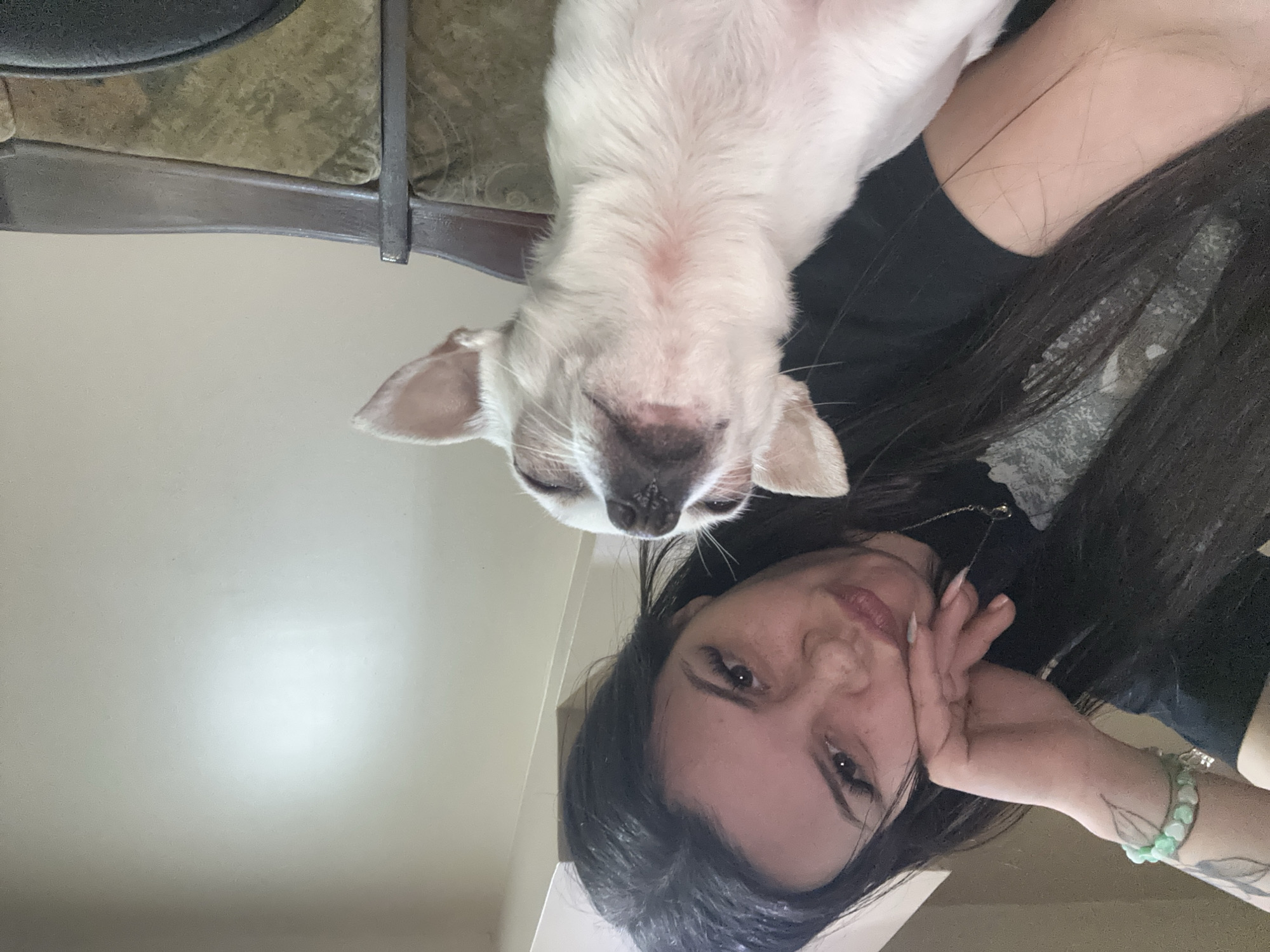 Woman takes selfies with small white dog in Sliven