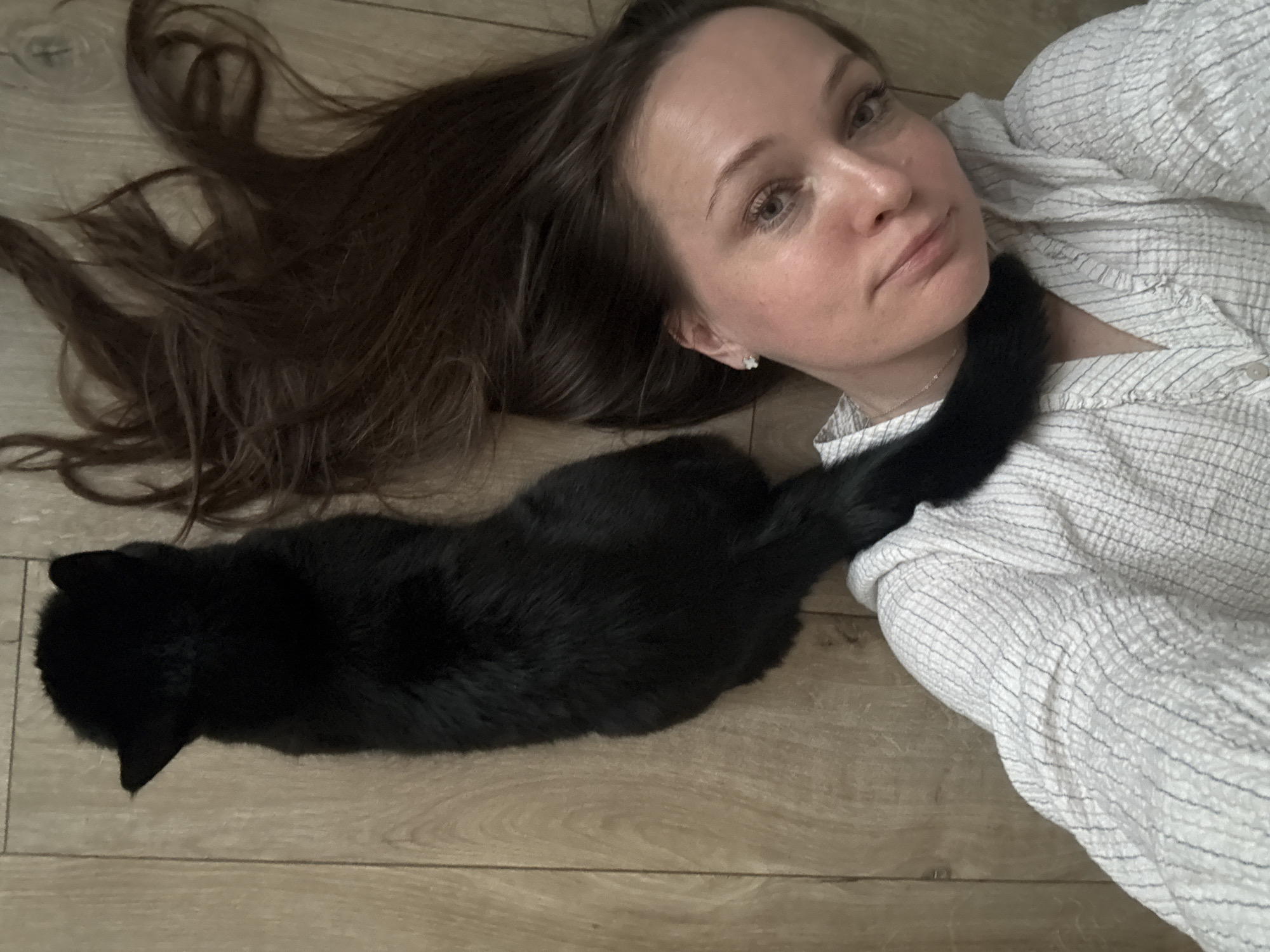 Woman and black cat photographed indoors, parks in Chaikovsky