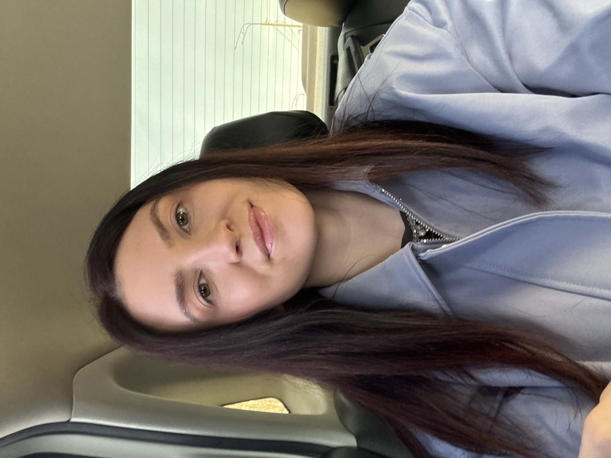 Woman in light blue jacket observed inside car in Kazan