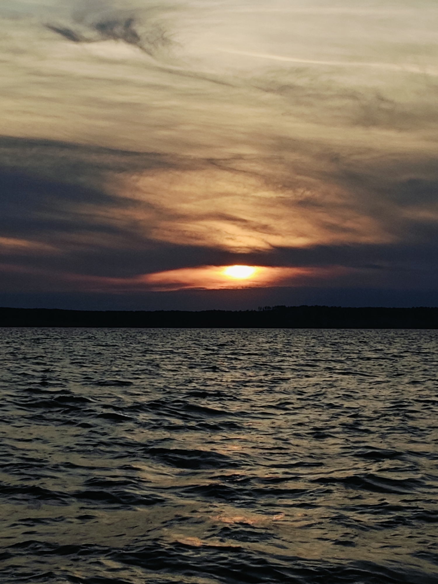 Fishing from an inflatable boat at sunset near Stepanovo