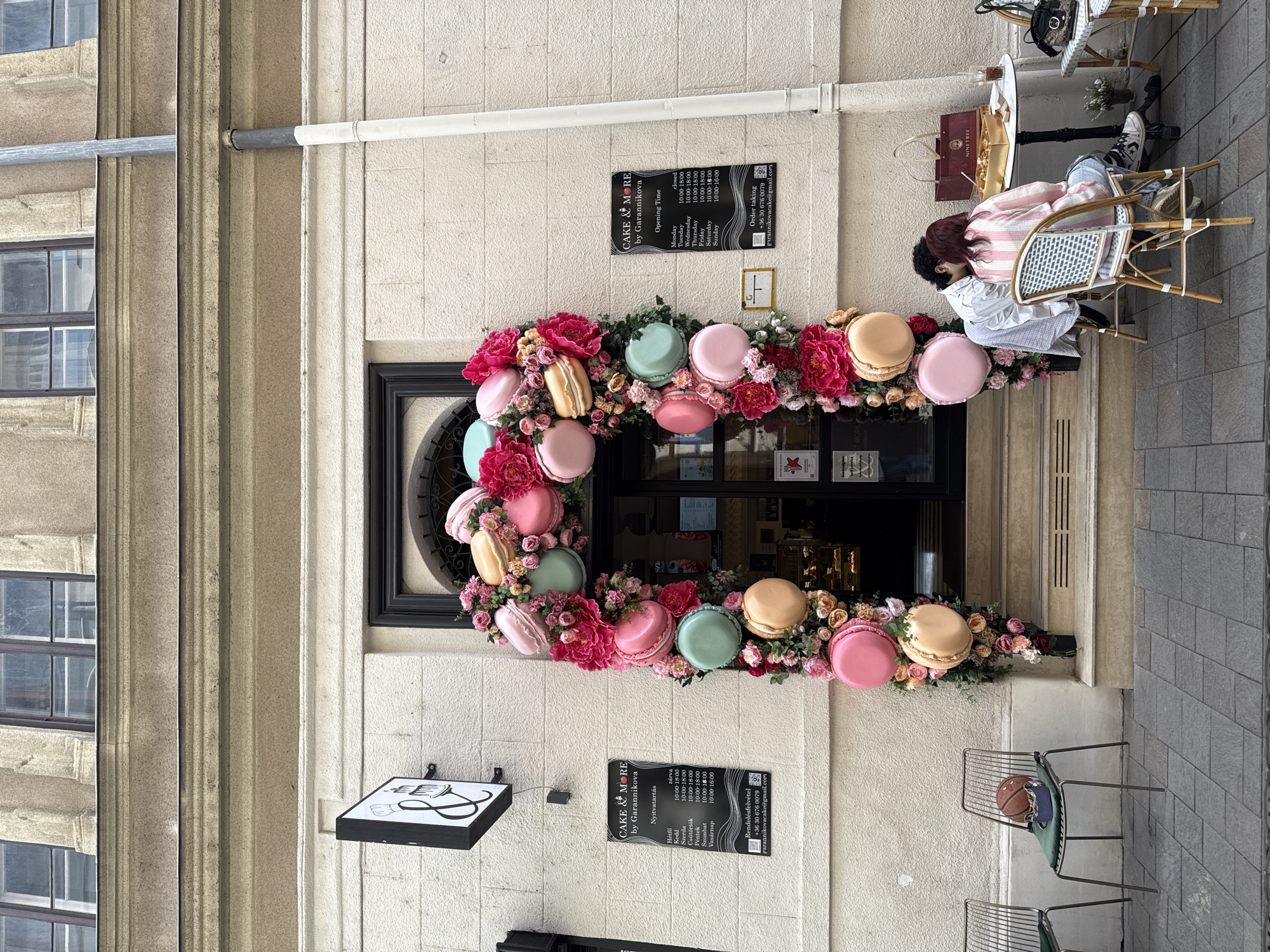 Scooter rider documents Budapest storefronts and architecture