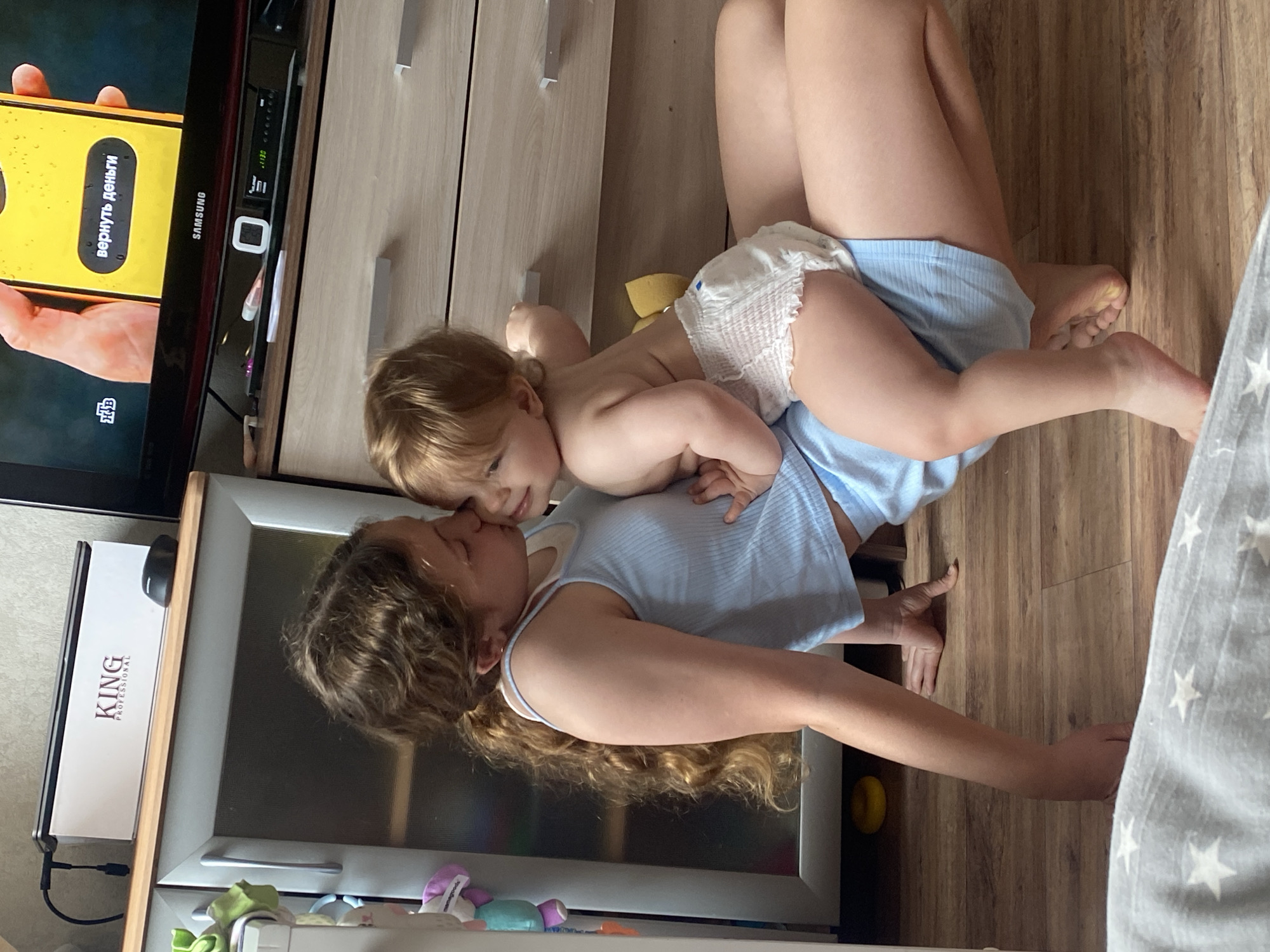 Woman and toddler share floor time indoors