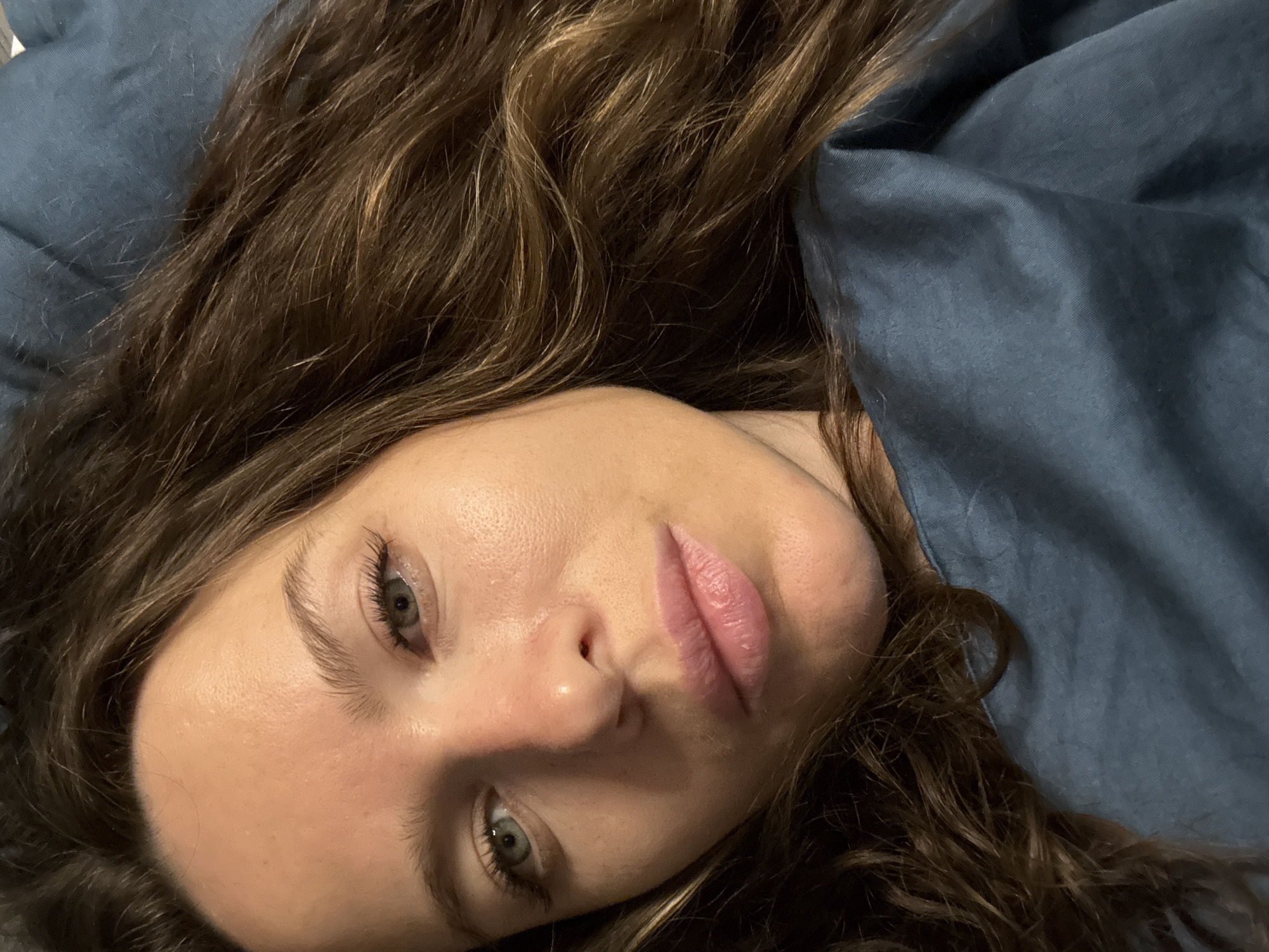 Woman resting on blue bedding captured in Dolgoprudny