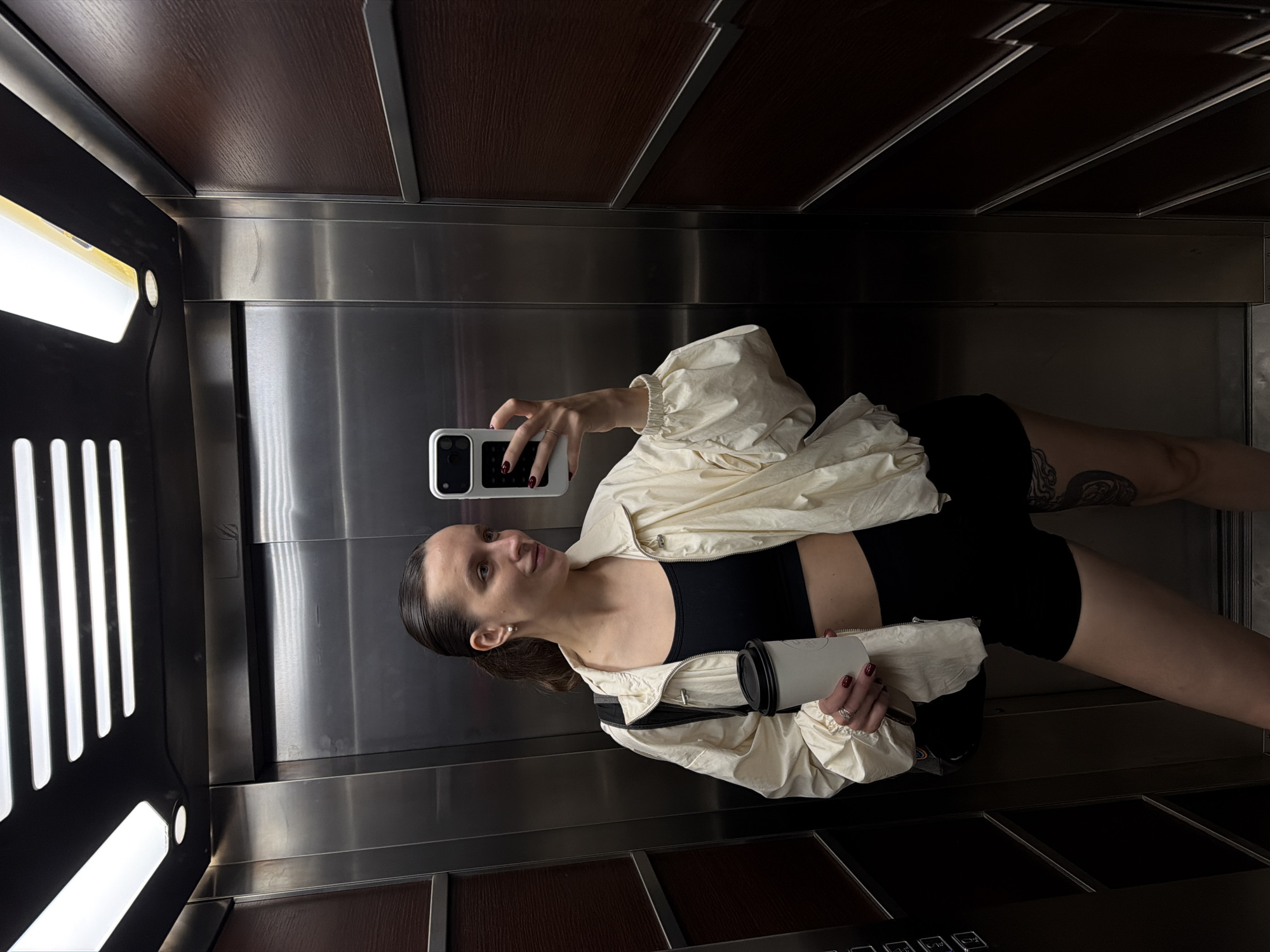 Woman takes elevator selfie in athletic wear in Budva