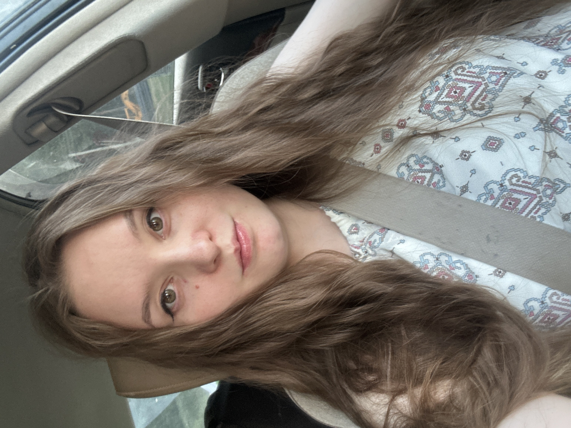 Woman photographed in car passenger seat in Noviy, Russia