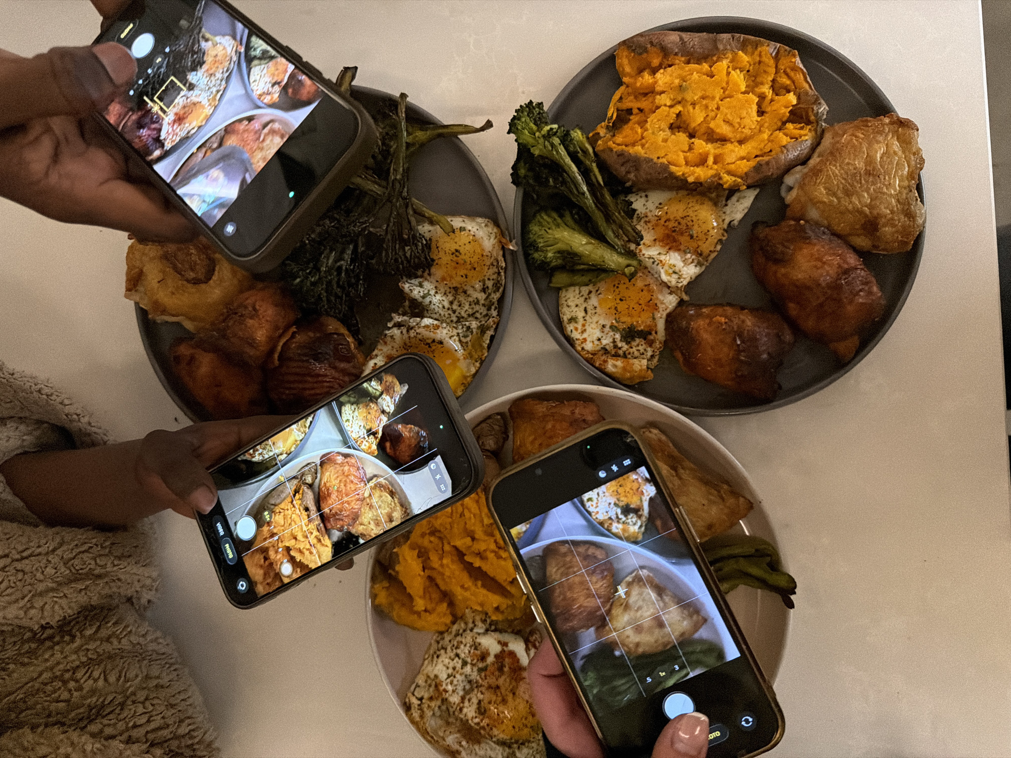 Three diners photograph meals simultaneously in London