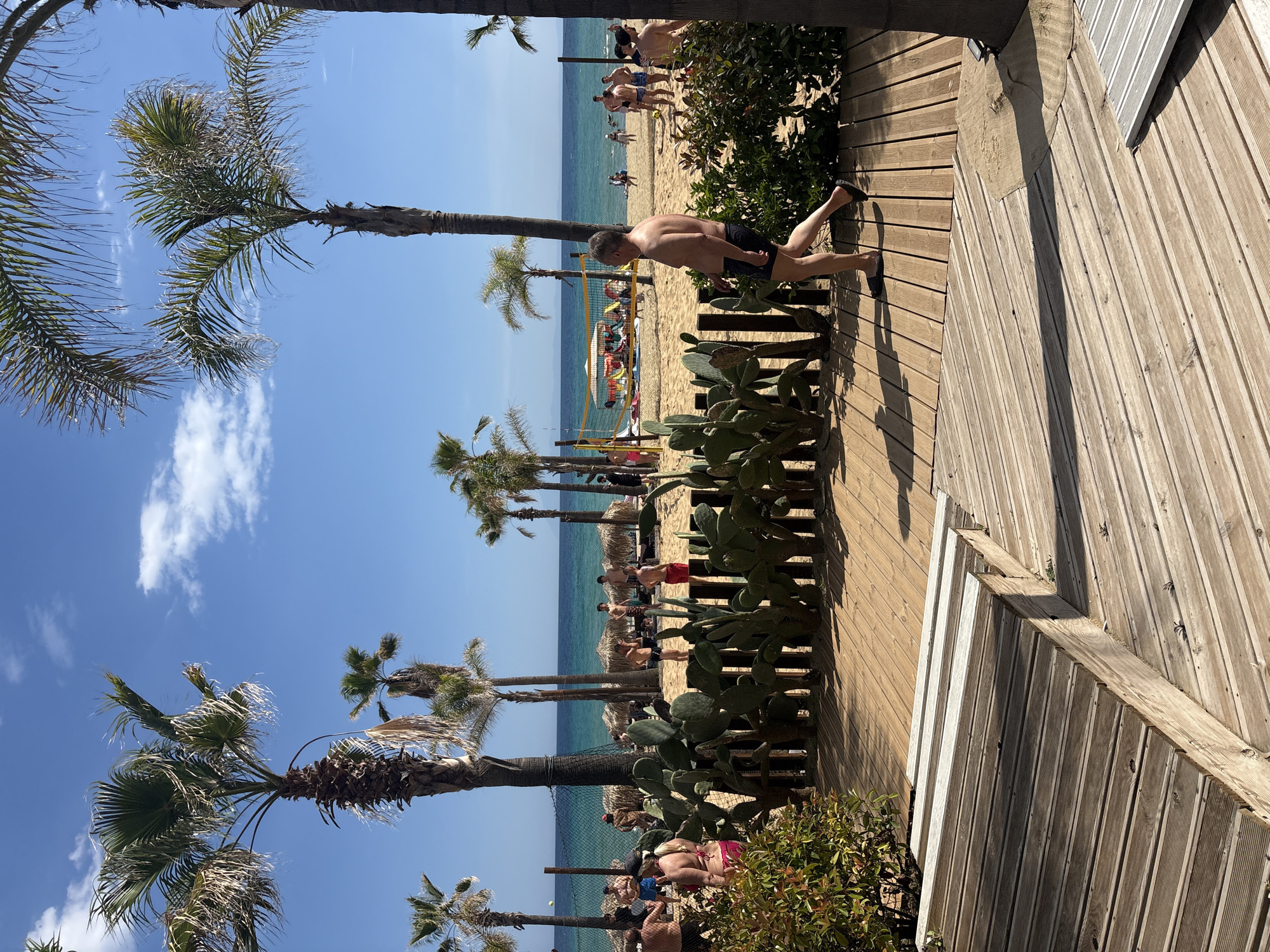 Beach day captured at Nea Peramos boardwalk with volleyball