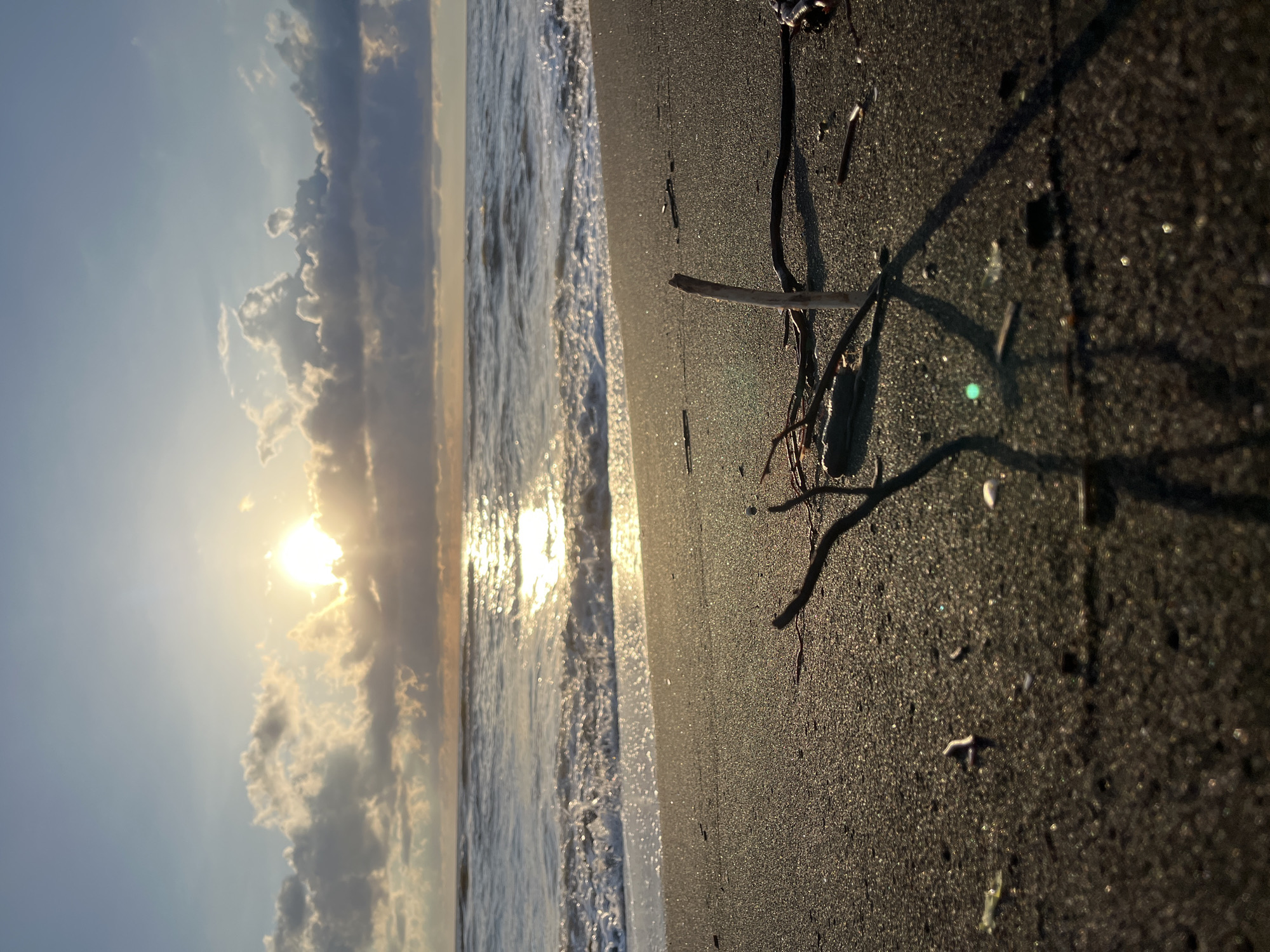 Golden light and dark sand on the Black Sea at Ureki