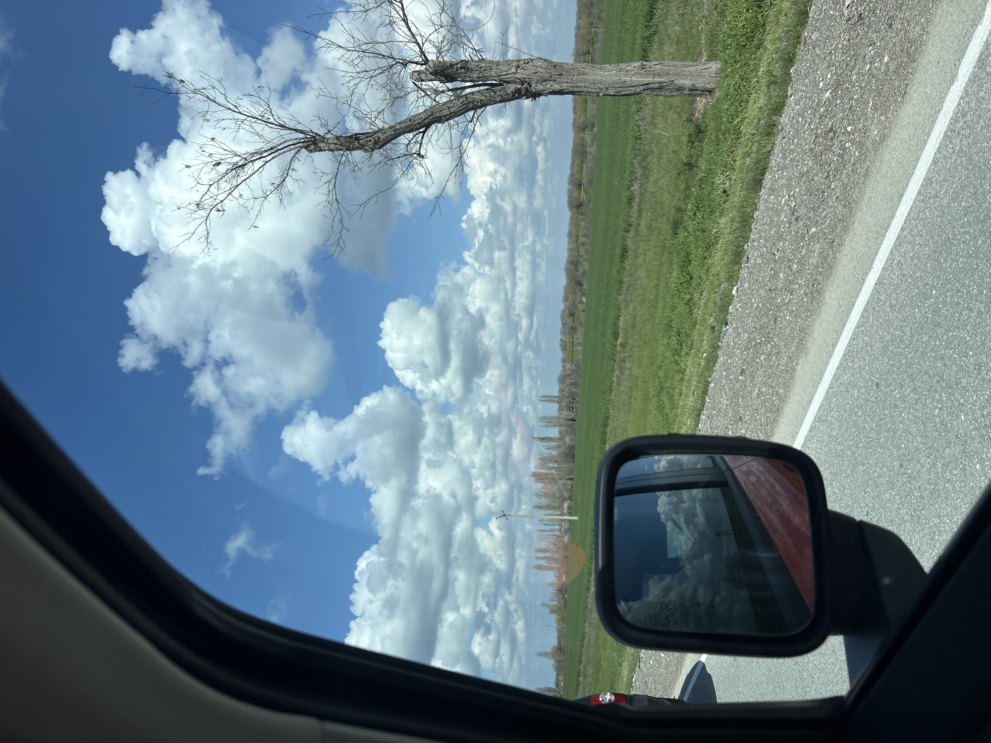 Vehicle travels through rural Ukrainian countryside under cloudy skies