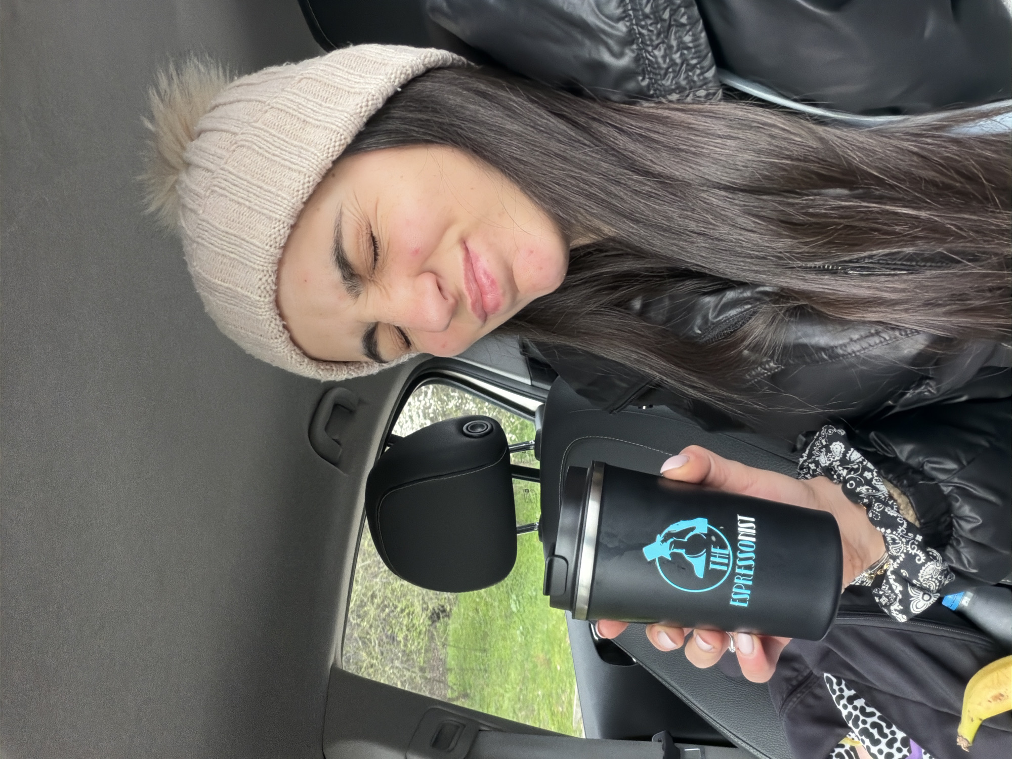 Woman enjoys coffee from car in Sofia