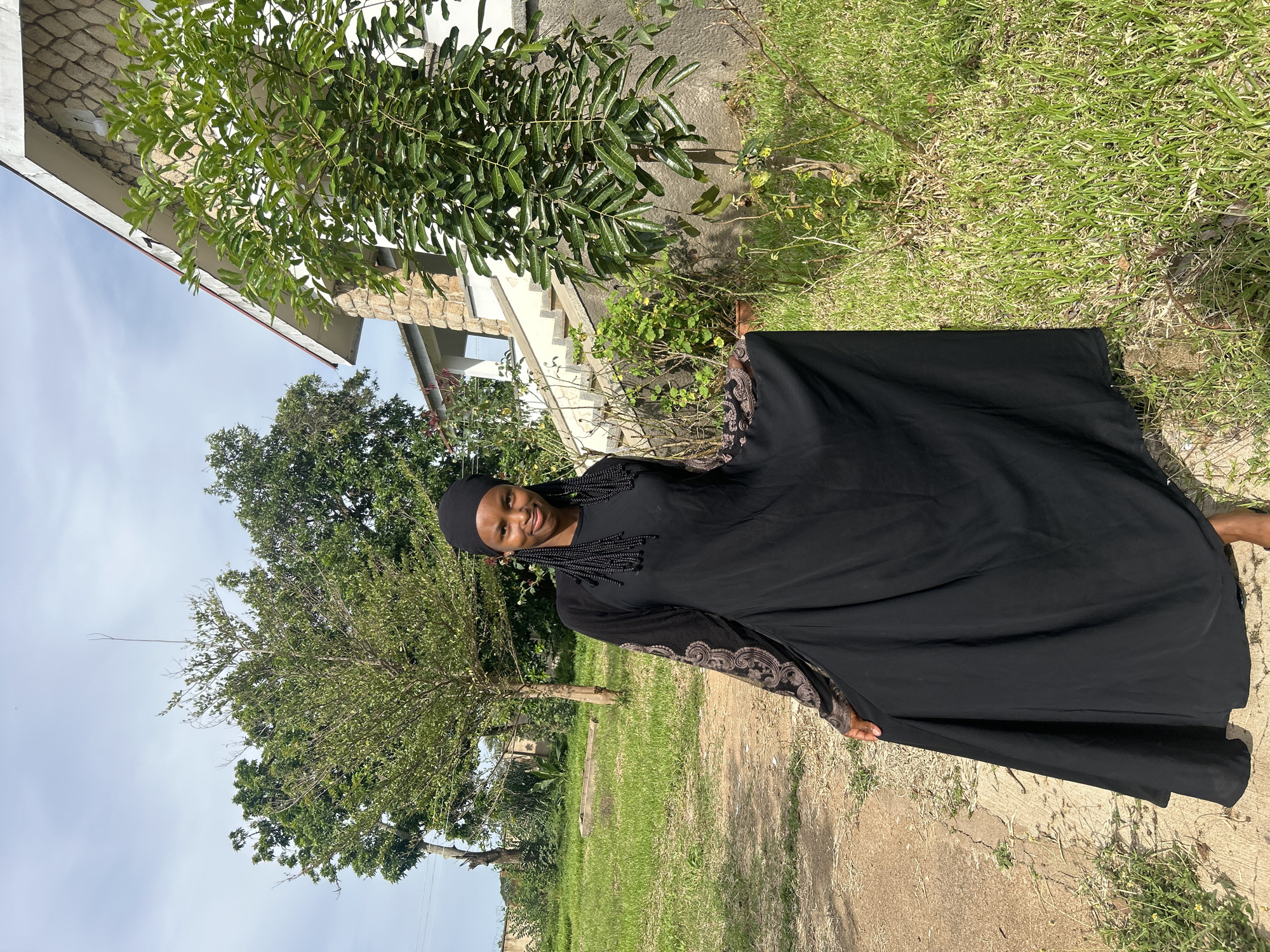 Posing outside a stone building in Vom, Nigeria