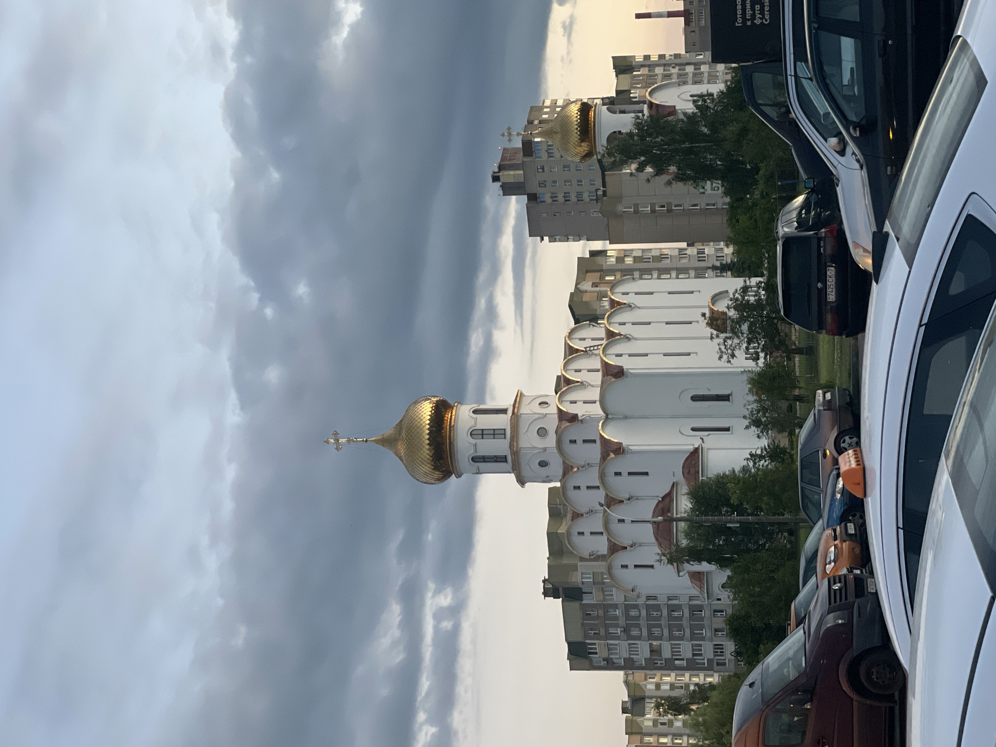 Orthodox church and Brutalist apartments share a Minsk street corner