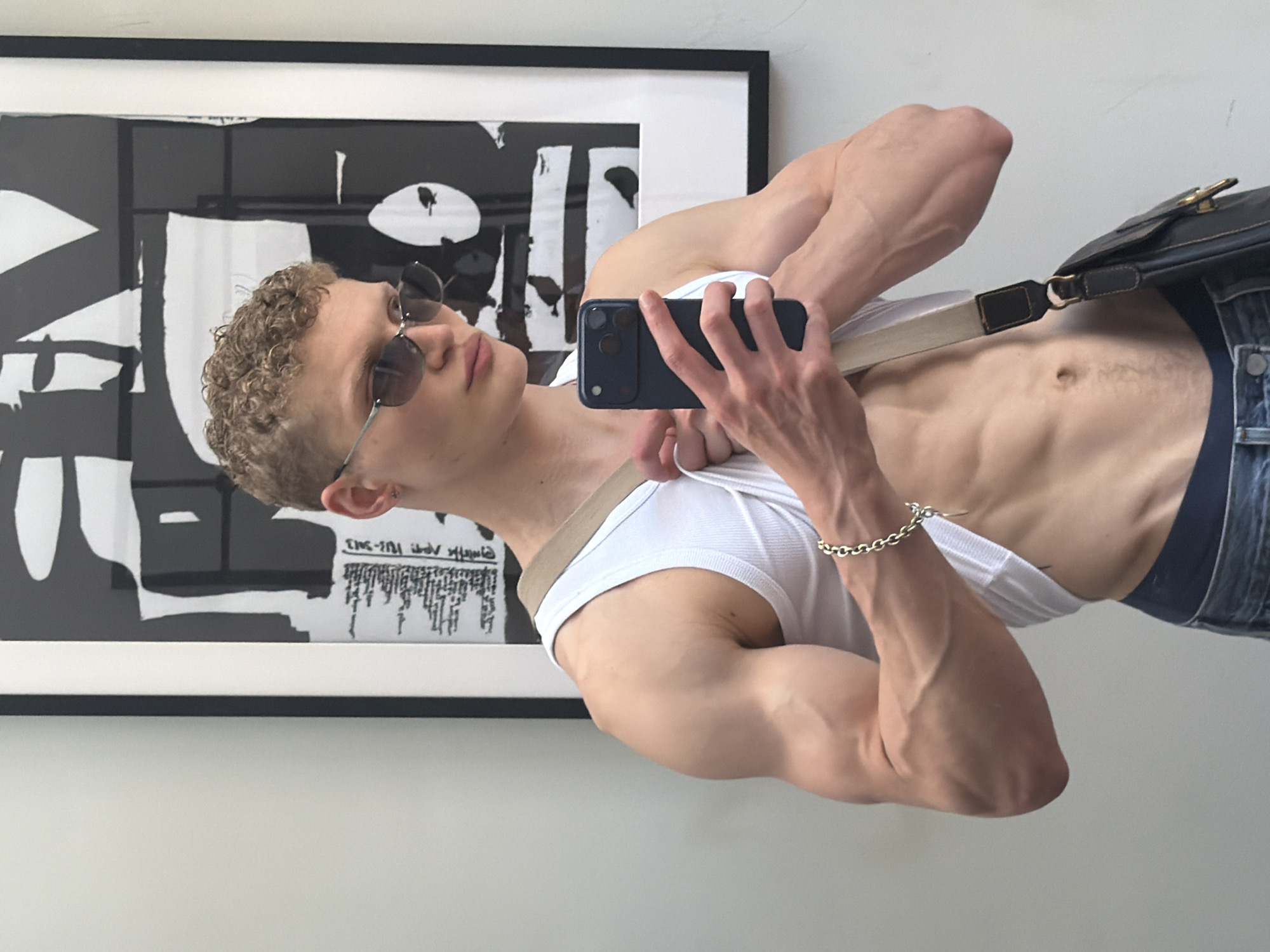Young man takes multiple mirror selfies in London