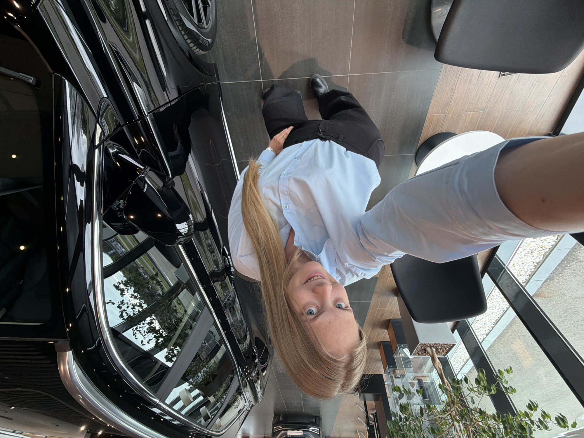 Woman takes selfies in modern building in Izhevsk