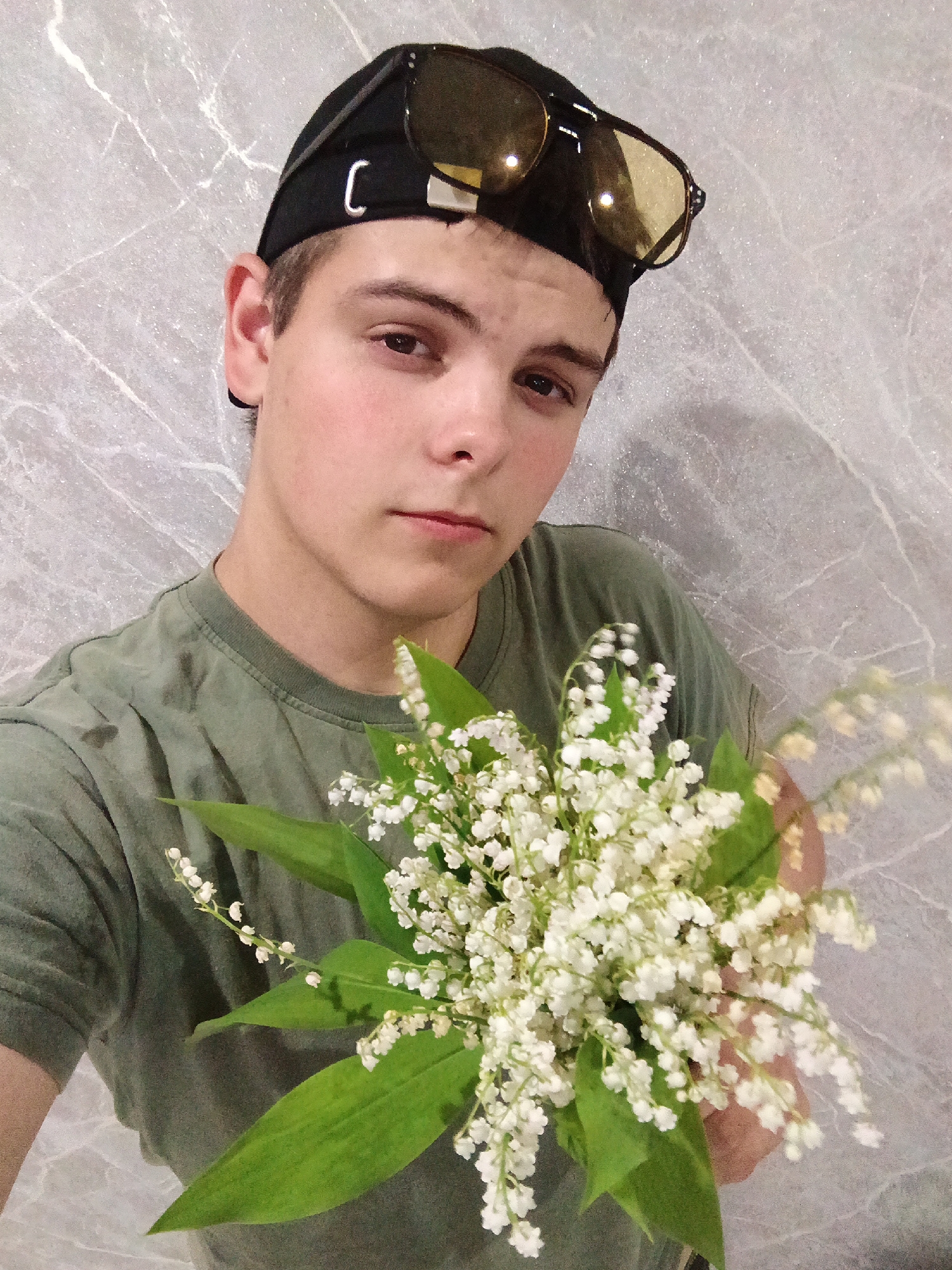 Young person poses with lily flowers in Andreyevo