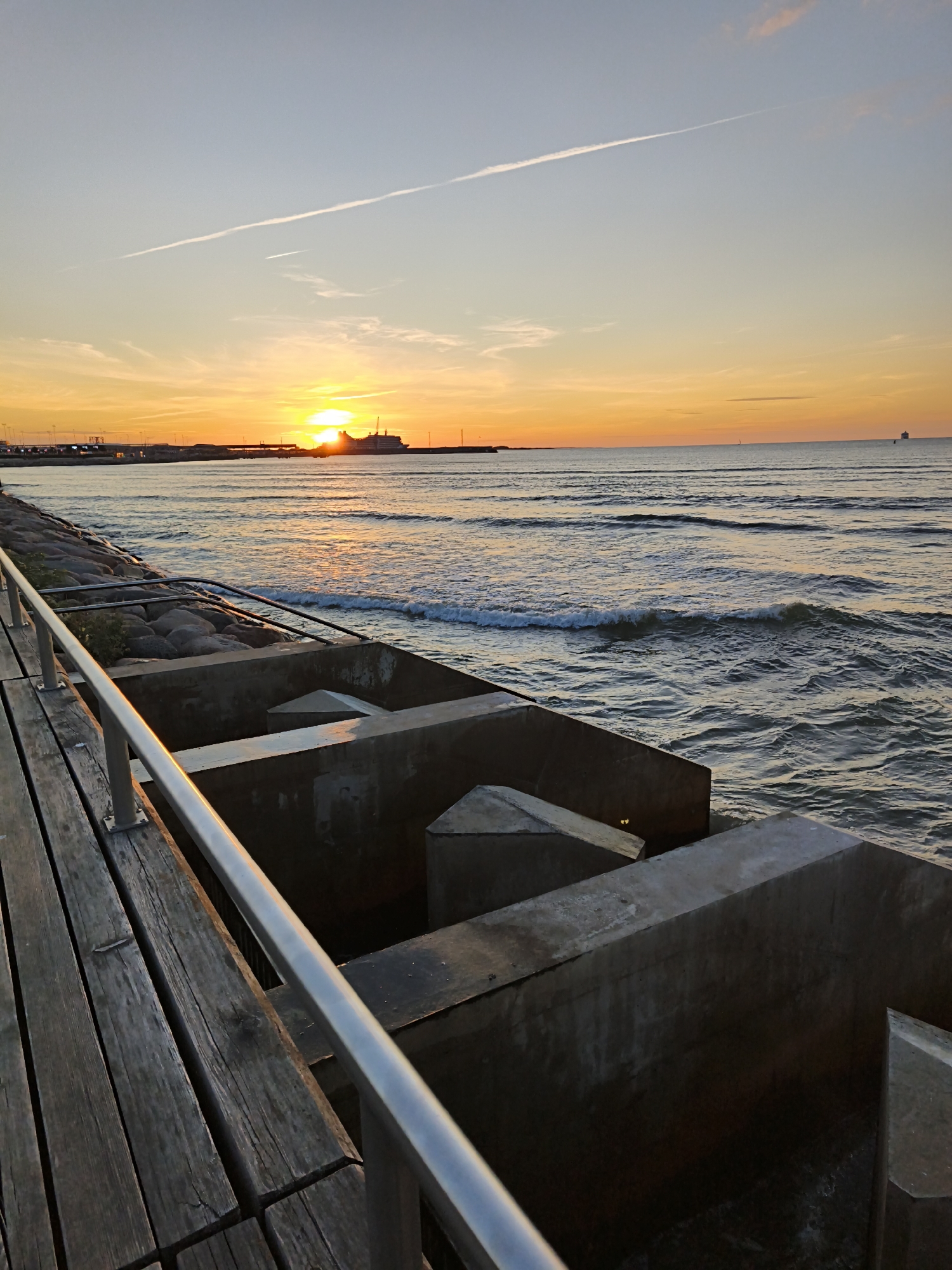 Baltic sunset from Tallinn's waterfront with a ship on the horizon