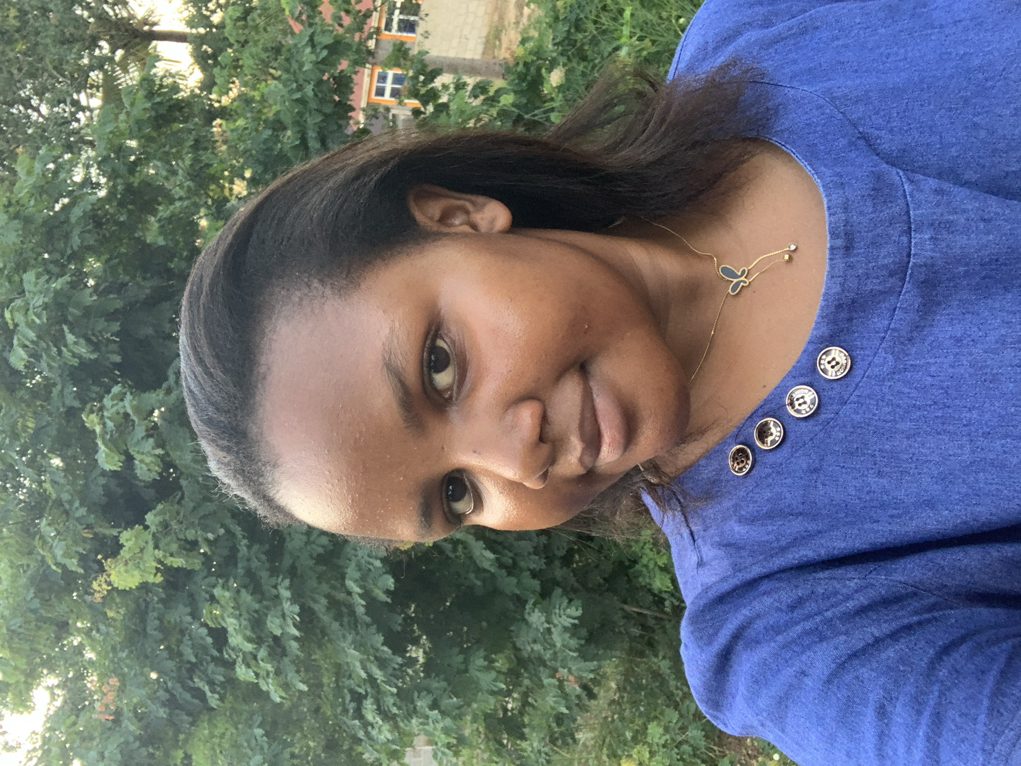 Woman in blue shirt spotted outdoors in Dar es Salaam