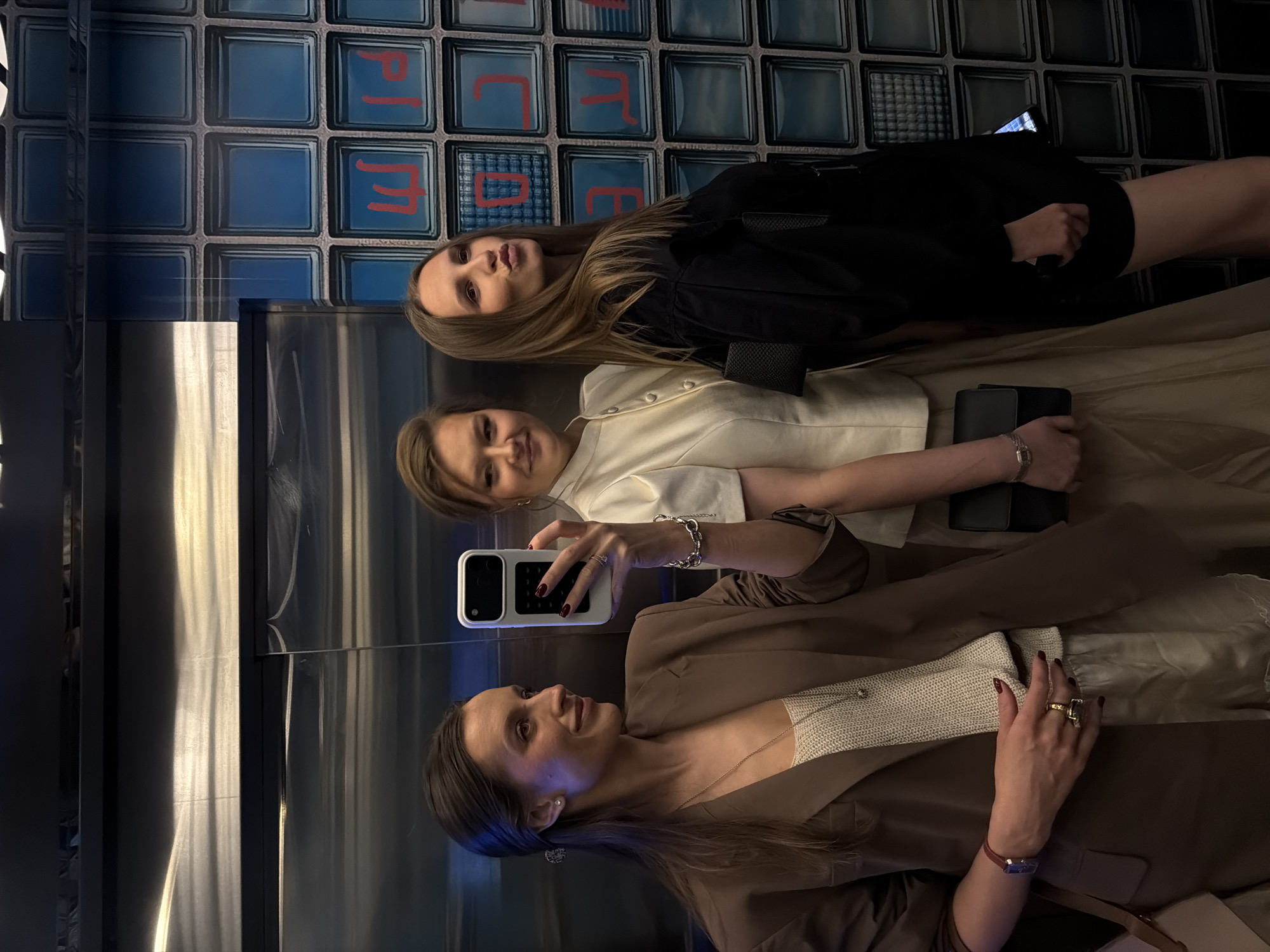 Women take selfies with flowers in Moscow elevator