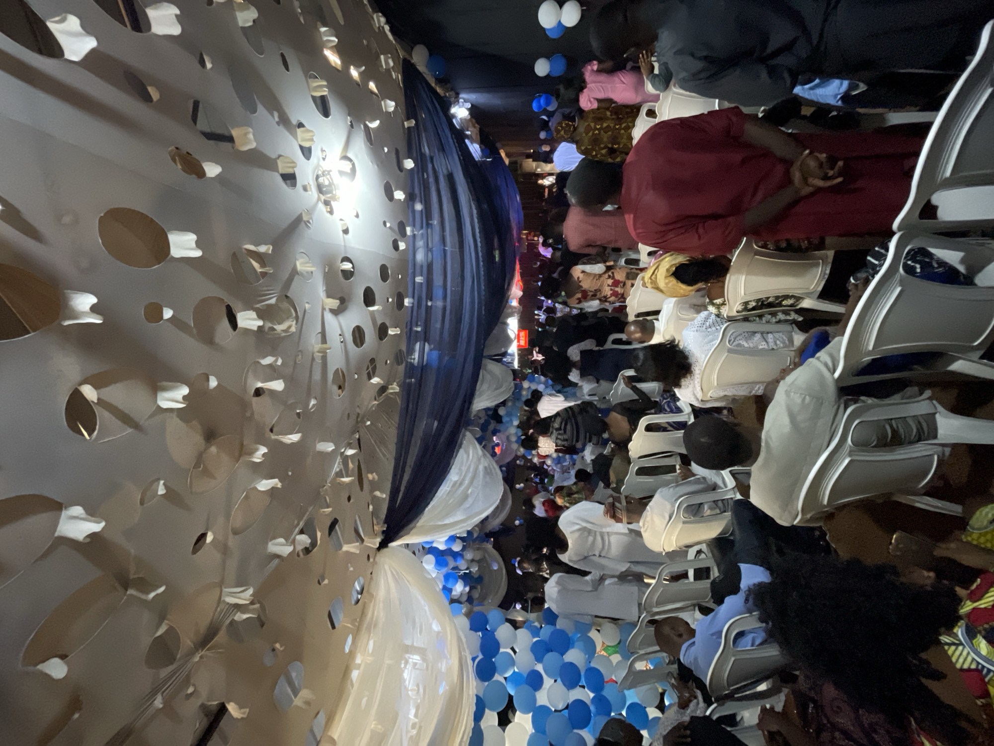 Indoor celebration with blue-white decorations across Nigerian venues