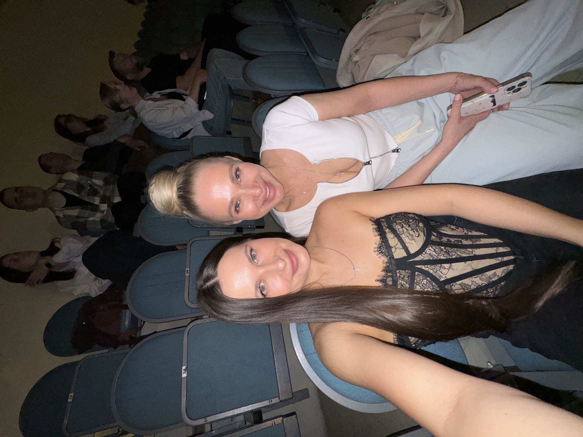 Two women take selfies at evening theater event in Odintsovo