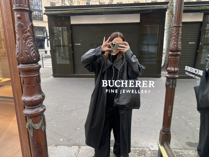 Woman takes mirror selfie on Paris street Sunday morning