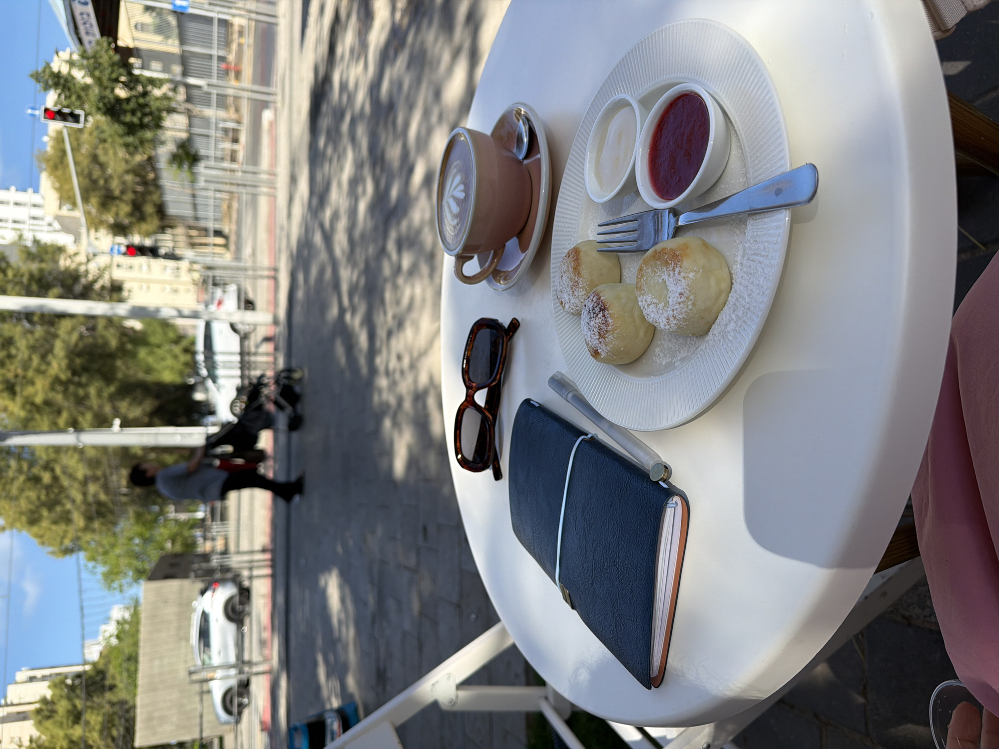 Morning breakfast captured at Bat Yam cafe with construction backdrop