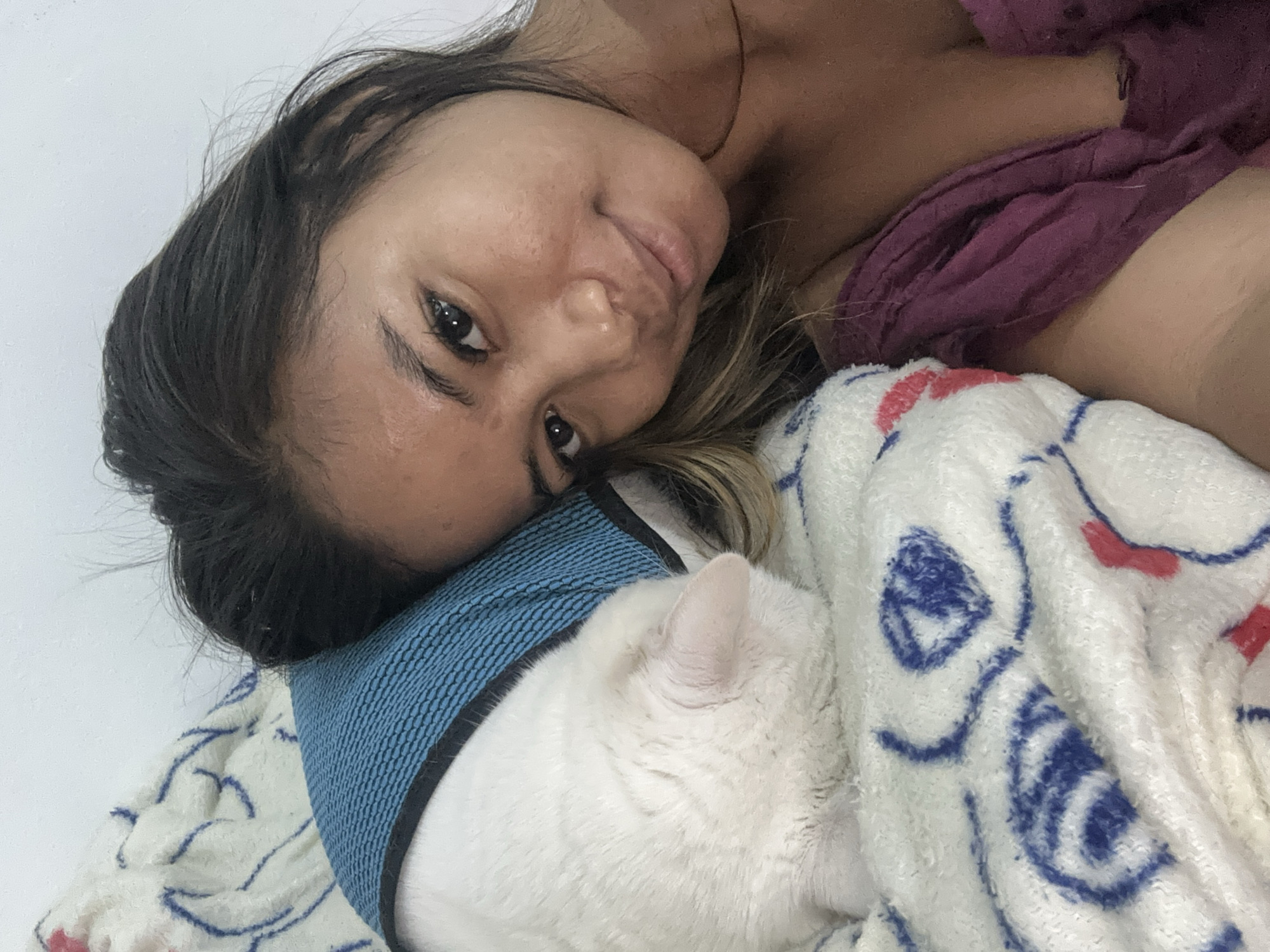 Woman and cat share quiet moments in Sukawati bedroom