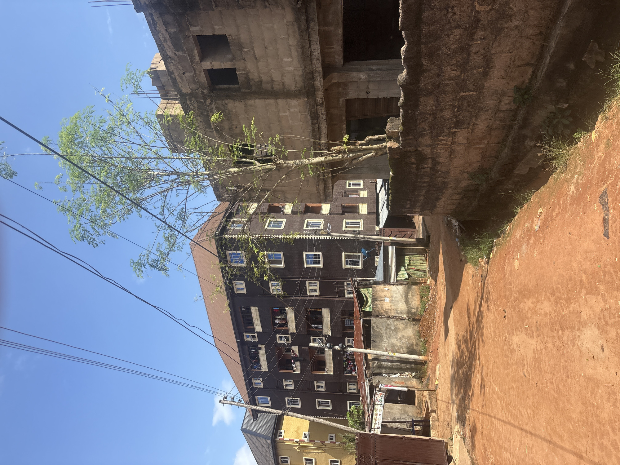 Street life and infrastructure along Nkpor's dusty unpaved roads