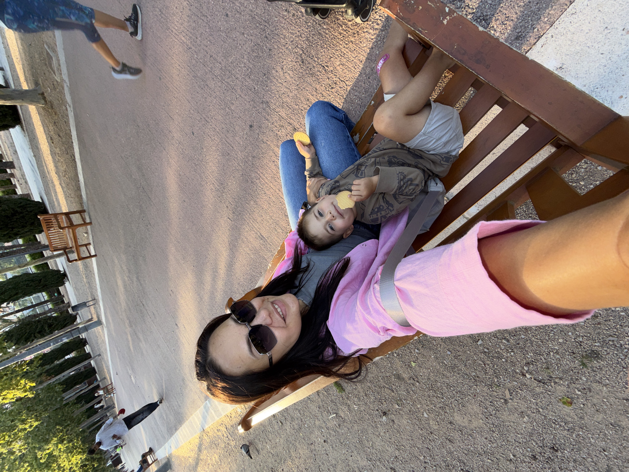 Mother and child enjoy afternoon playground visit with selfies