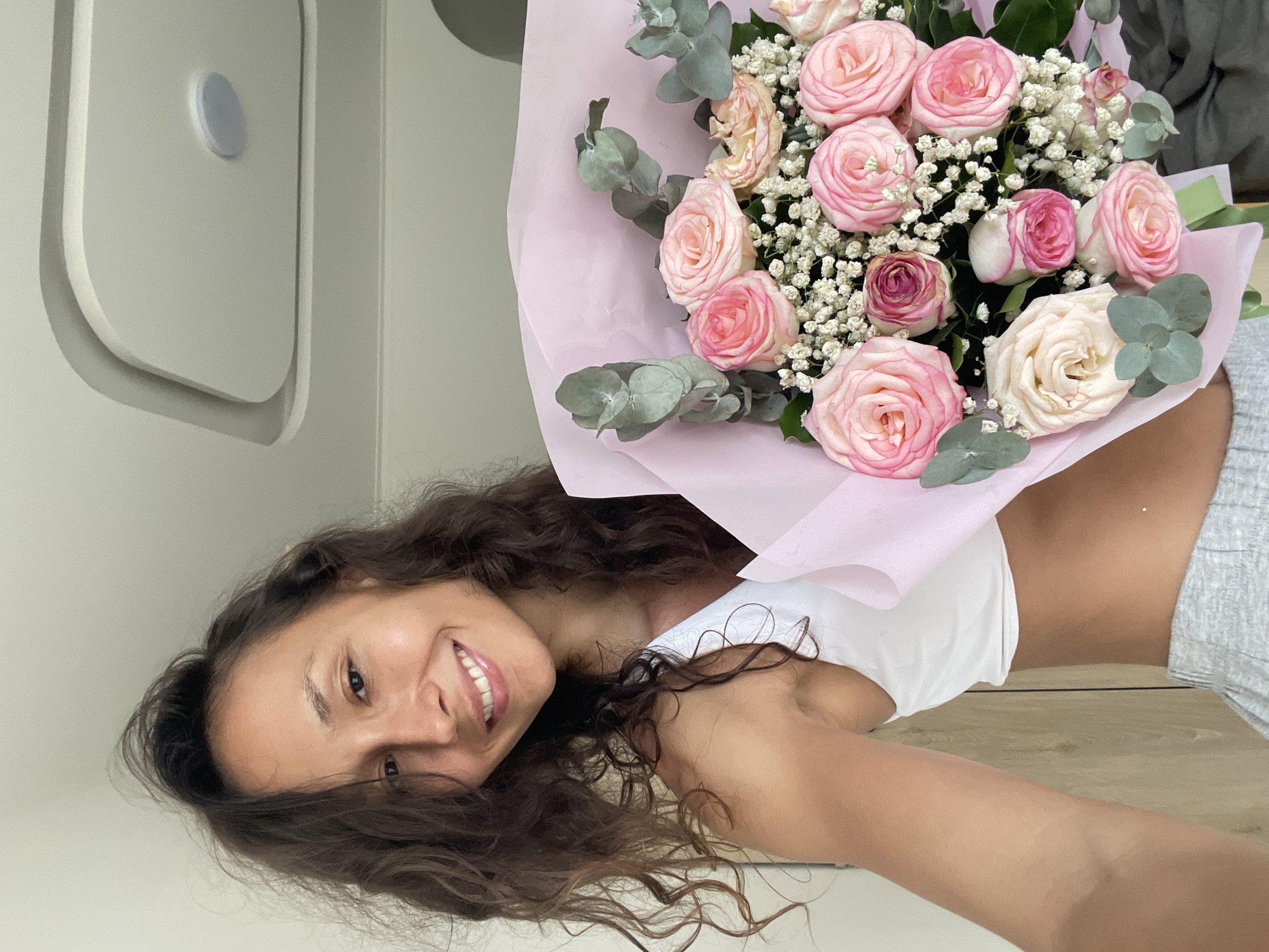 Woman poses with rose bouquet in Vietnamese photoshoot session
