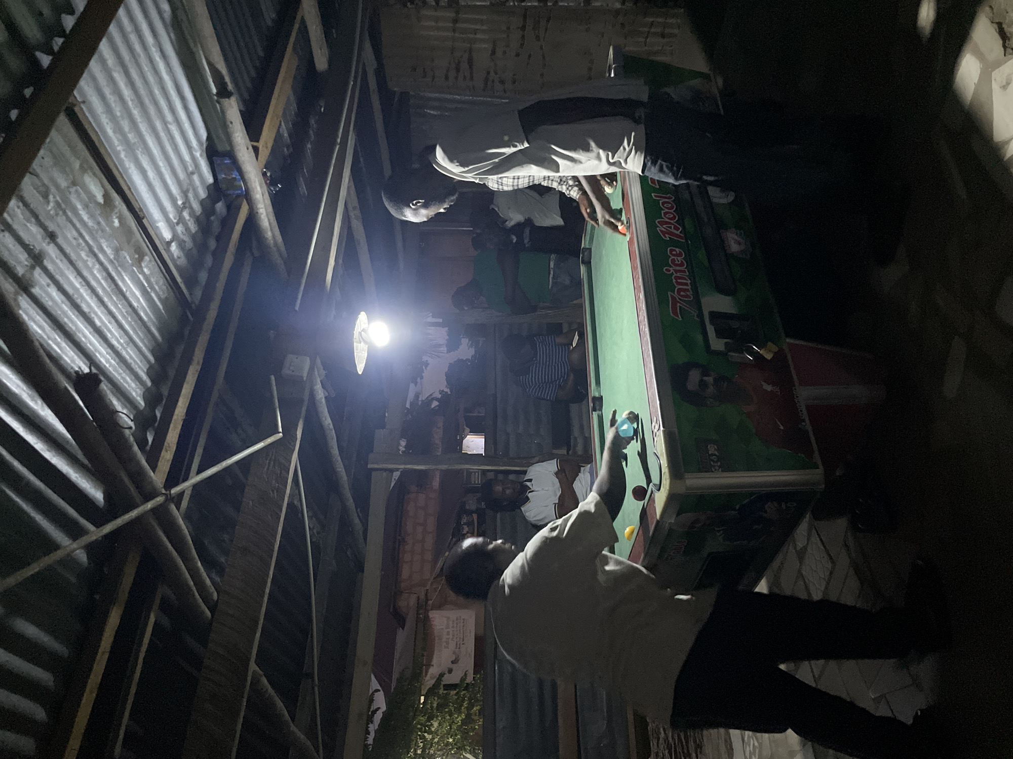 Pool tables, dim interiors, and street-level repairs in Dar es Salaam