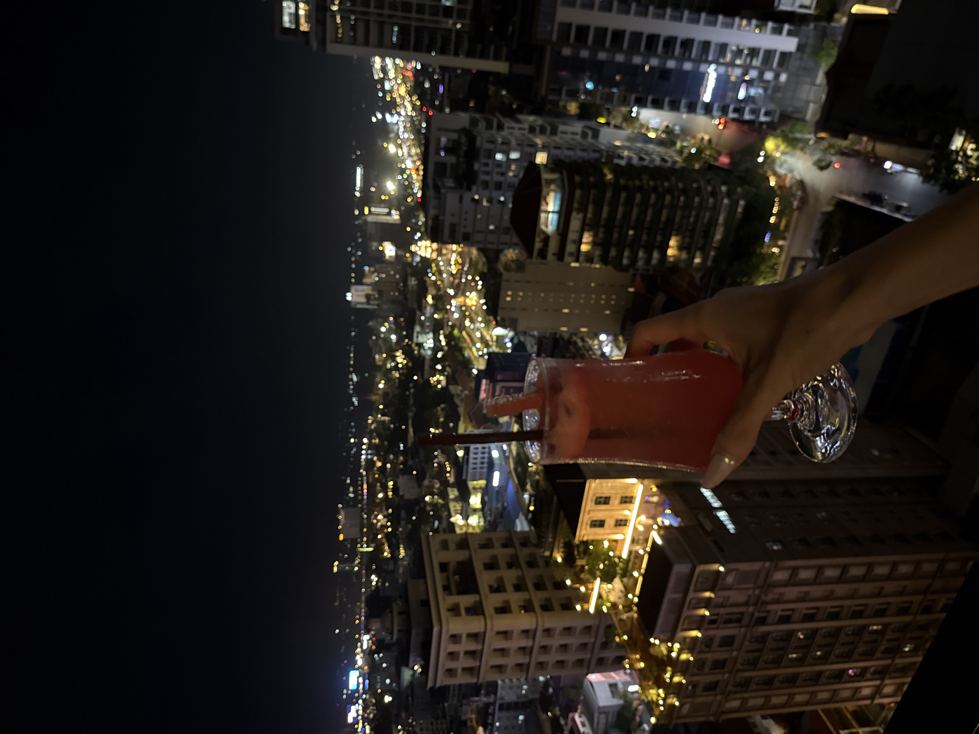 Rooftop cocktails and city lights in Phnom Penh at night