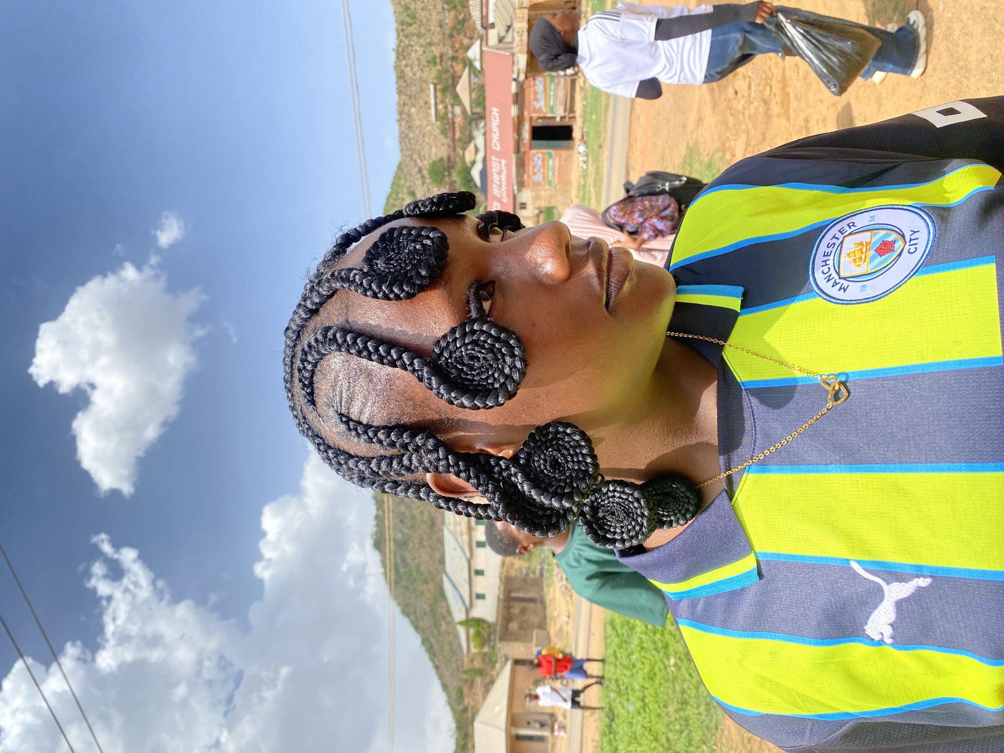Woman in Manchester City jersey photographed in Gwong, Nigeria