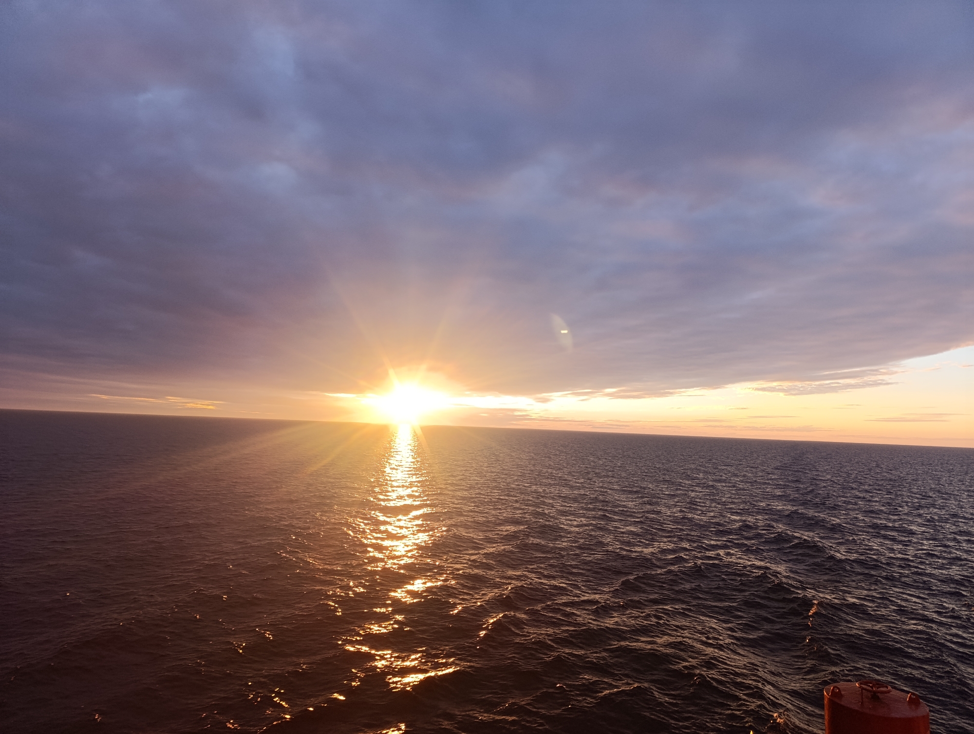 Golden sunset over open water off the Swedish coast