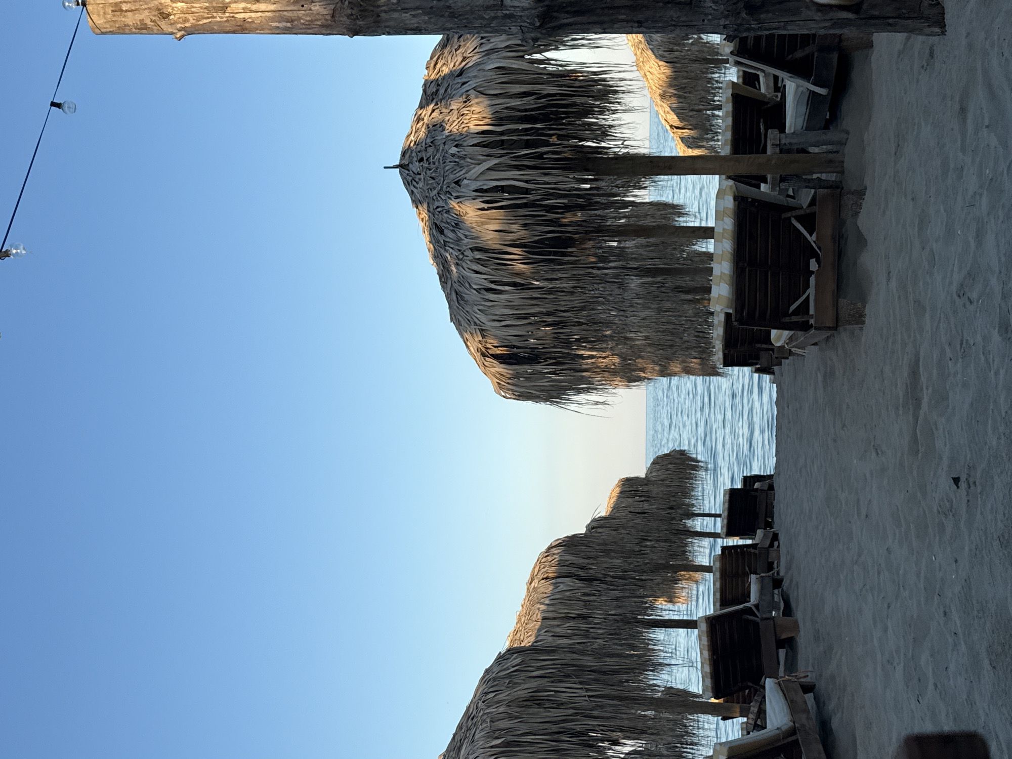 Empty beach chairs and wooden shade structures, Kranevo