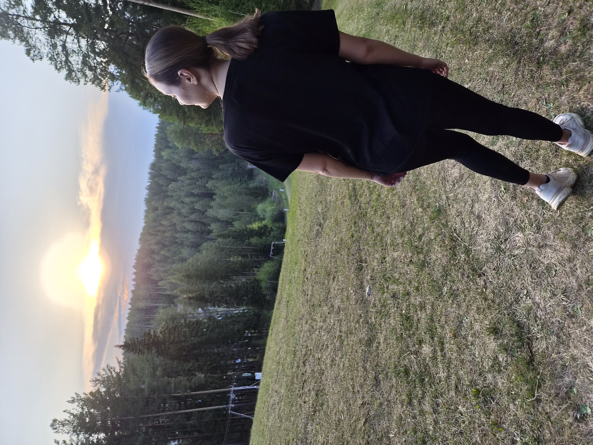 Woman exercises outdoors during sunset in Прикамский, Russia