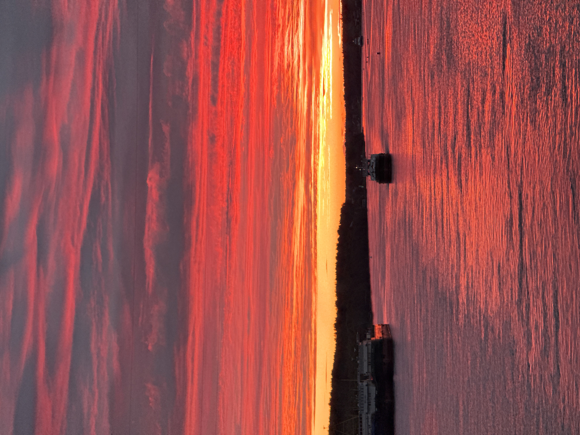 Fiery sky over the Svir River, viewed from the water