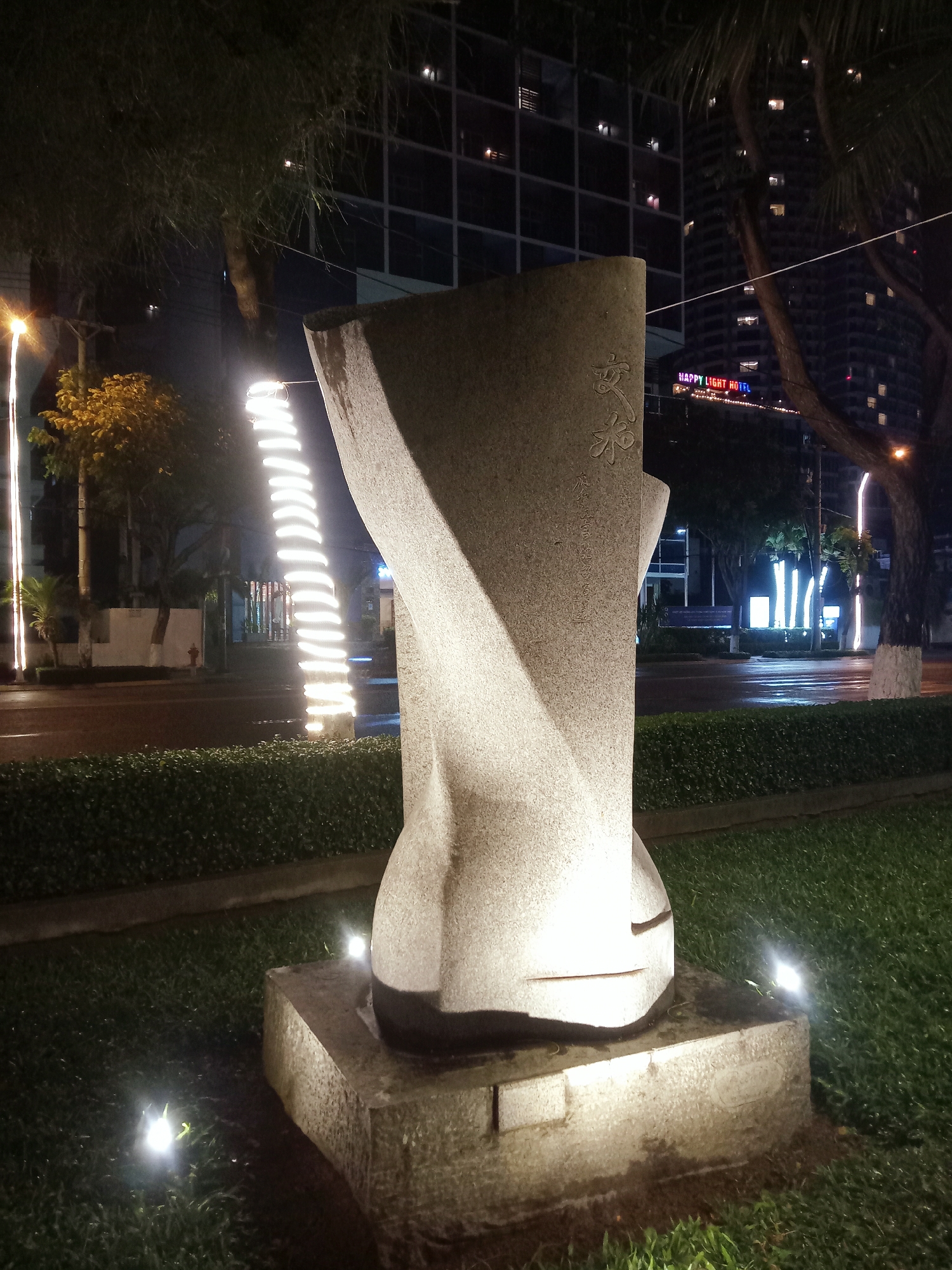 Stone sculpture fountain documented in Nha Trang park evening