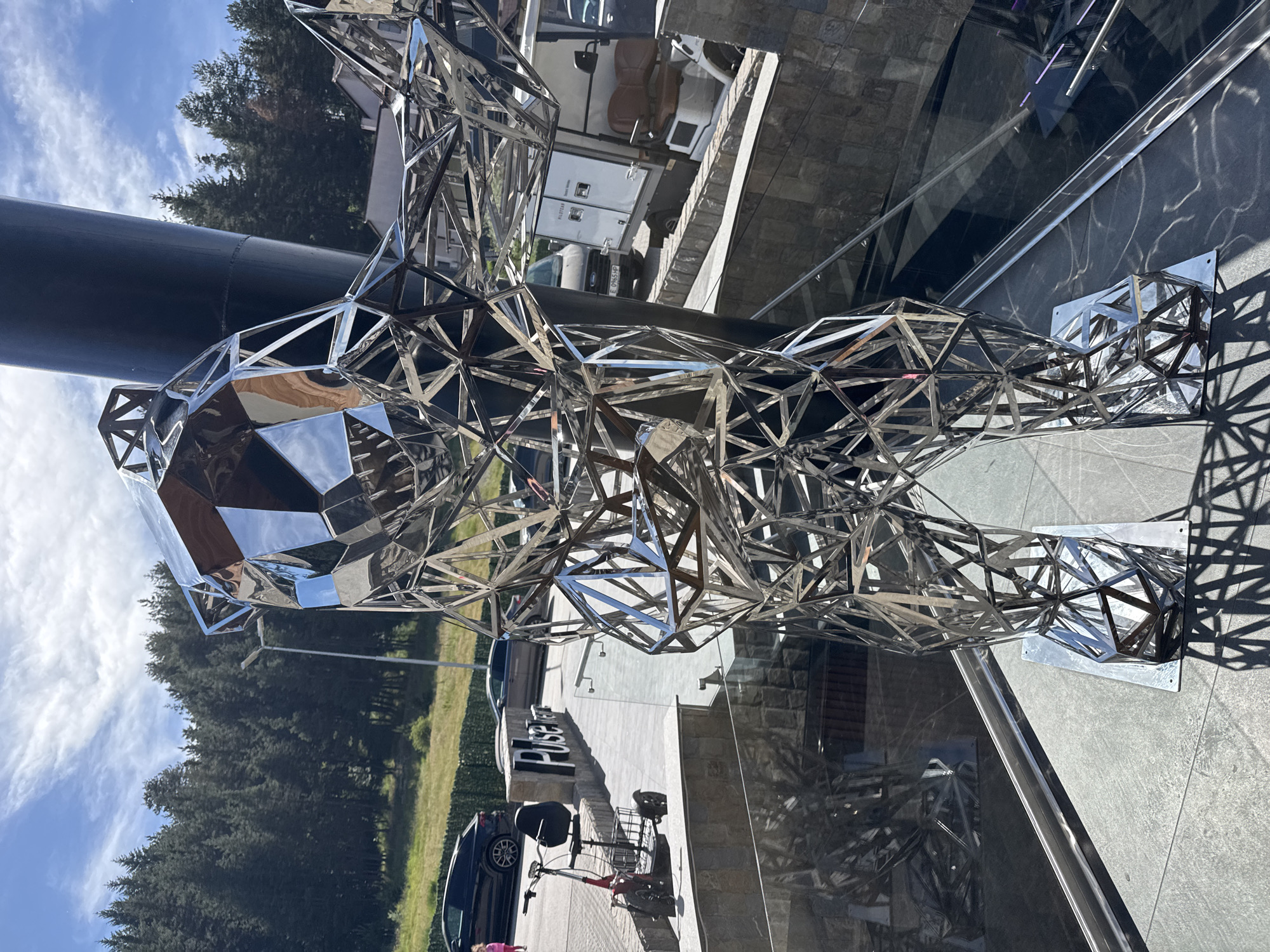 Geometric bear sculpture and casual moments captured around outdoor plaza
