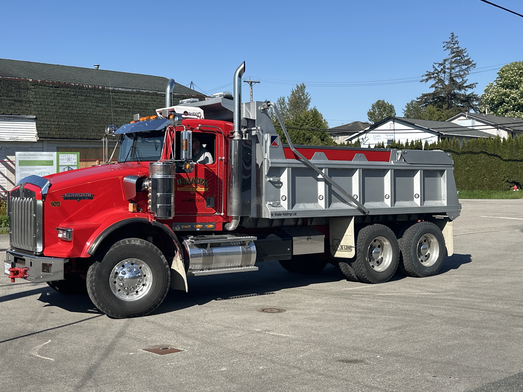Red dump truck photographed multiple times in Surrey