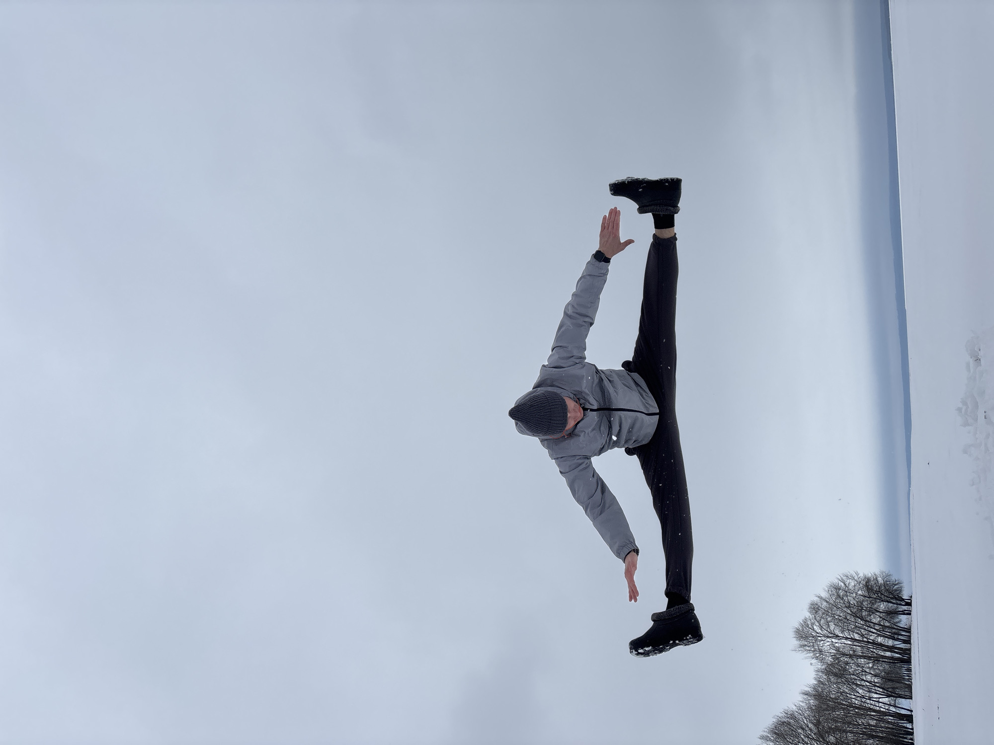 Man performs split pose in snow in Noviy, Russia