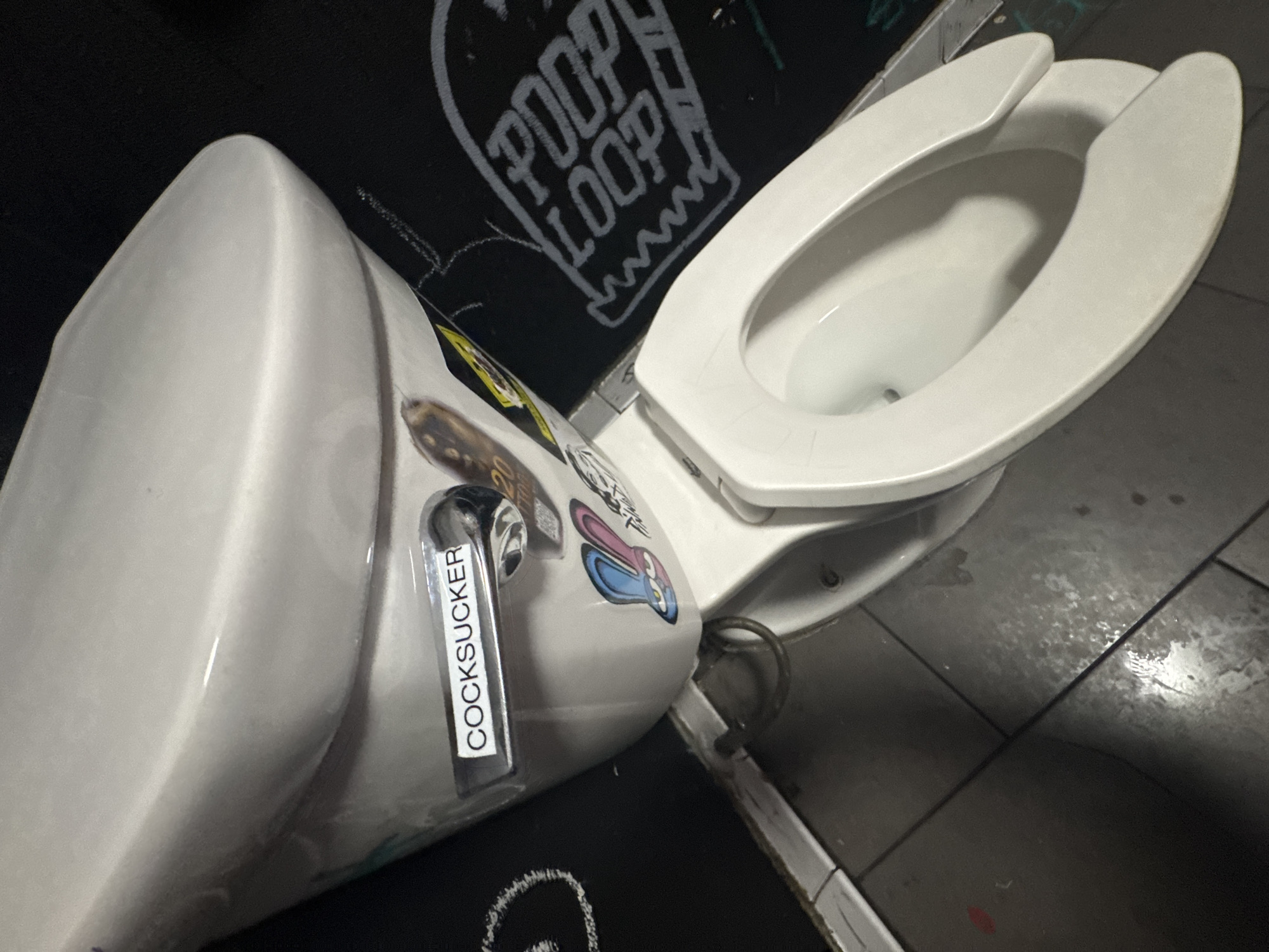 Vandalized restroom documented in Las Vegas with graffiti and stickers