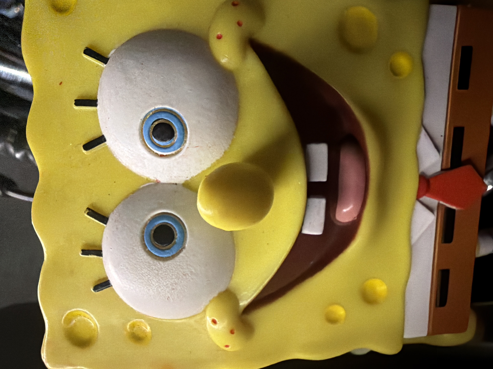 SpongeBob figurine posed and photographed on a motorcycle