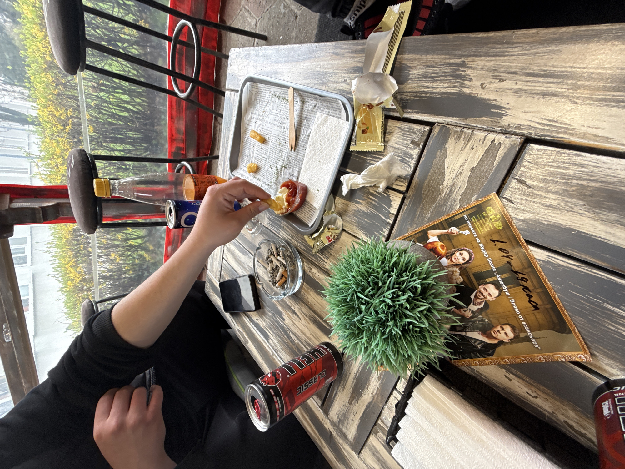 Person enjoys french fries at outdoor cafe in Sliven